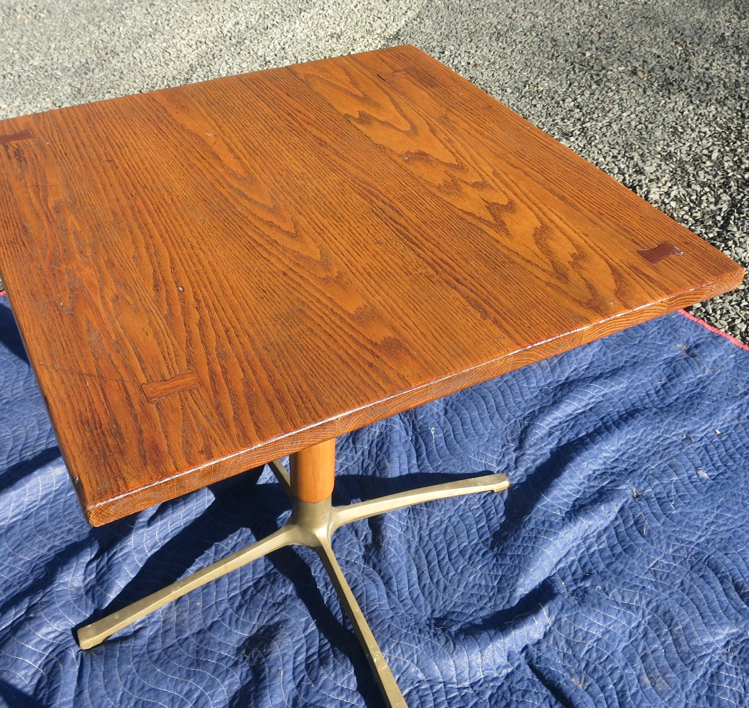 Nice oak top table with associated base. Base has brass feet. The top is 29