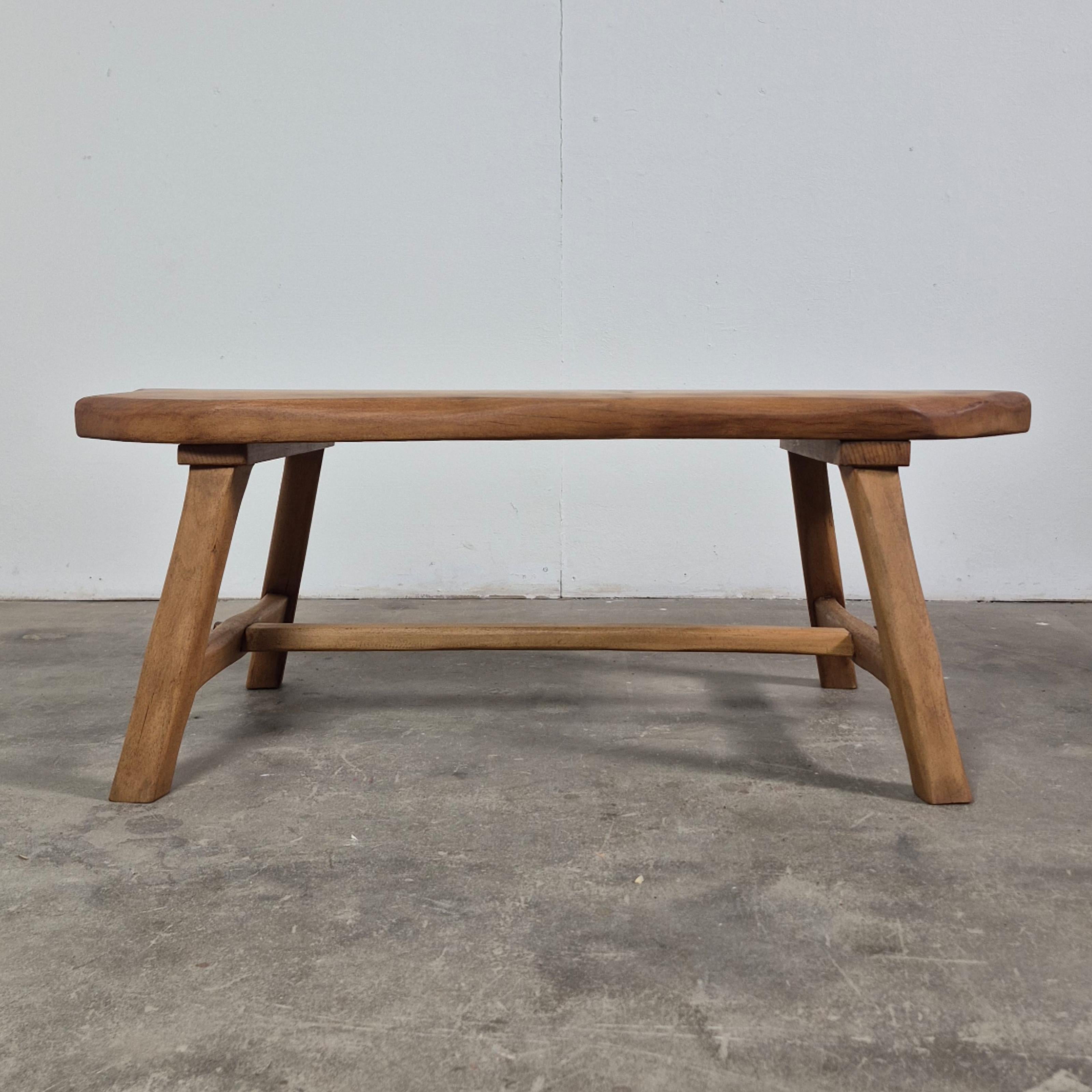 Wabi sabi coffee or side table. The top is made from a single piece of wood. The base is made from solid oak.

The top is fixed to the base with screws. The base itself has only wood through wood connections secured with wood wedges. 
