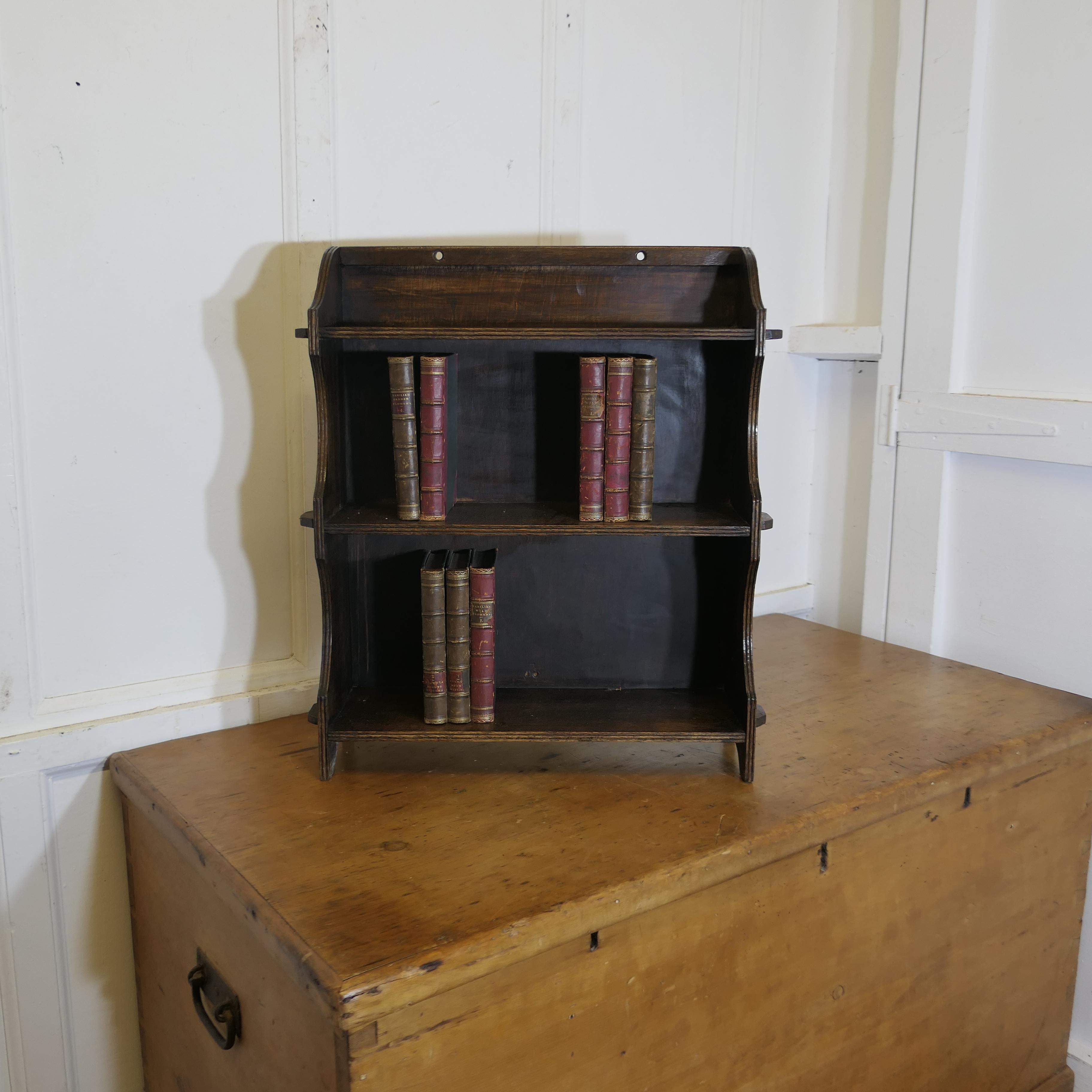 Oak Wall Hanging Shelf  

This charming little shelf unit has a solid back and the shelf has a scalloped edge with 3 shelves, it is in good condition and would work well in many room designs 
The Shelf is 7” deep, 21” long and 15” high
TCS193