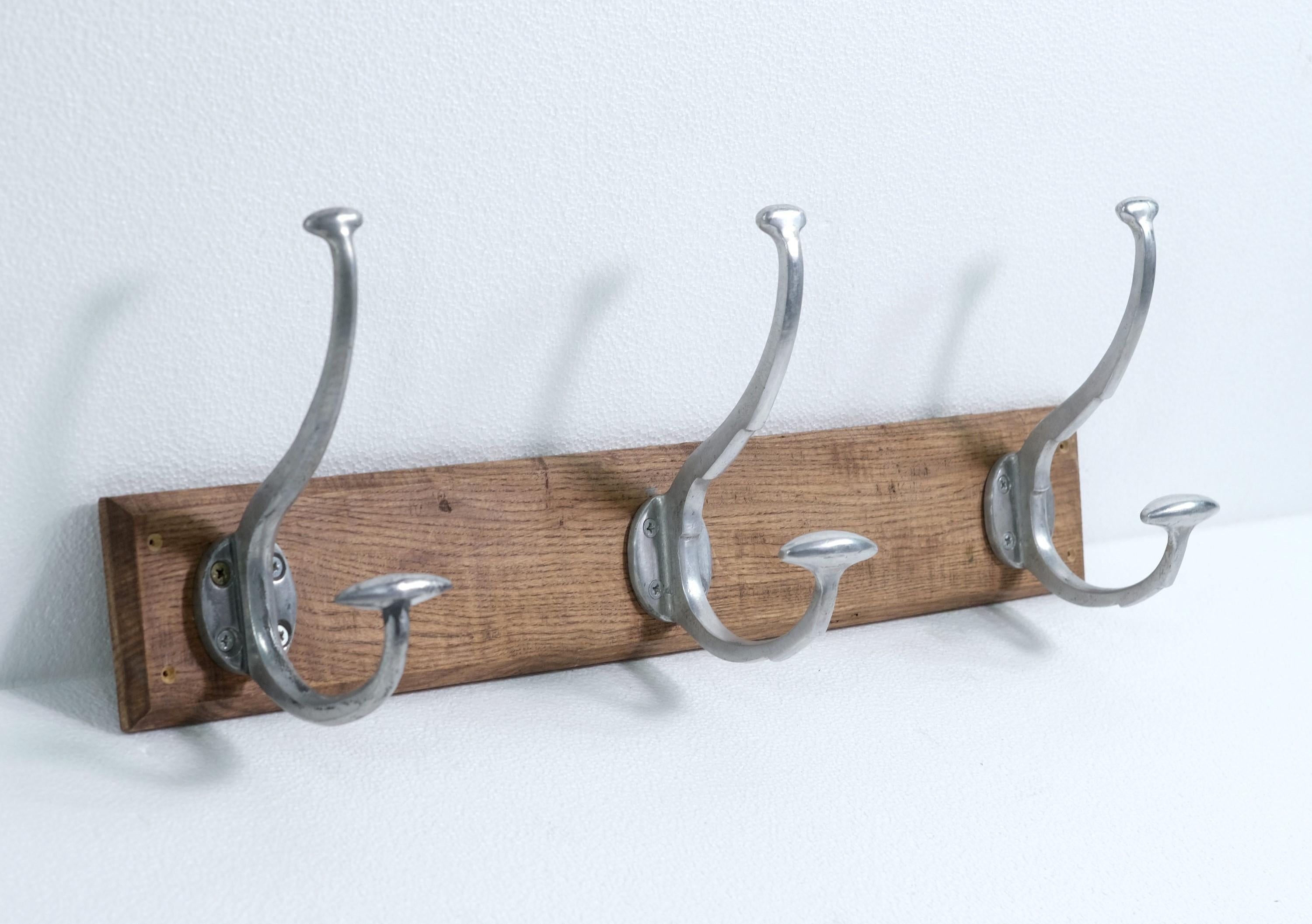 Mid-Century Modern style oak wall mounted hat and coat rack with three double arm aluminum hooks. One hook is a little different. Two are the same. Please see the photos. Please note, this item is located in our Scranton, PA location.