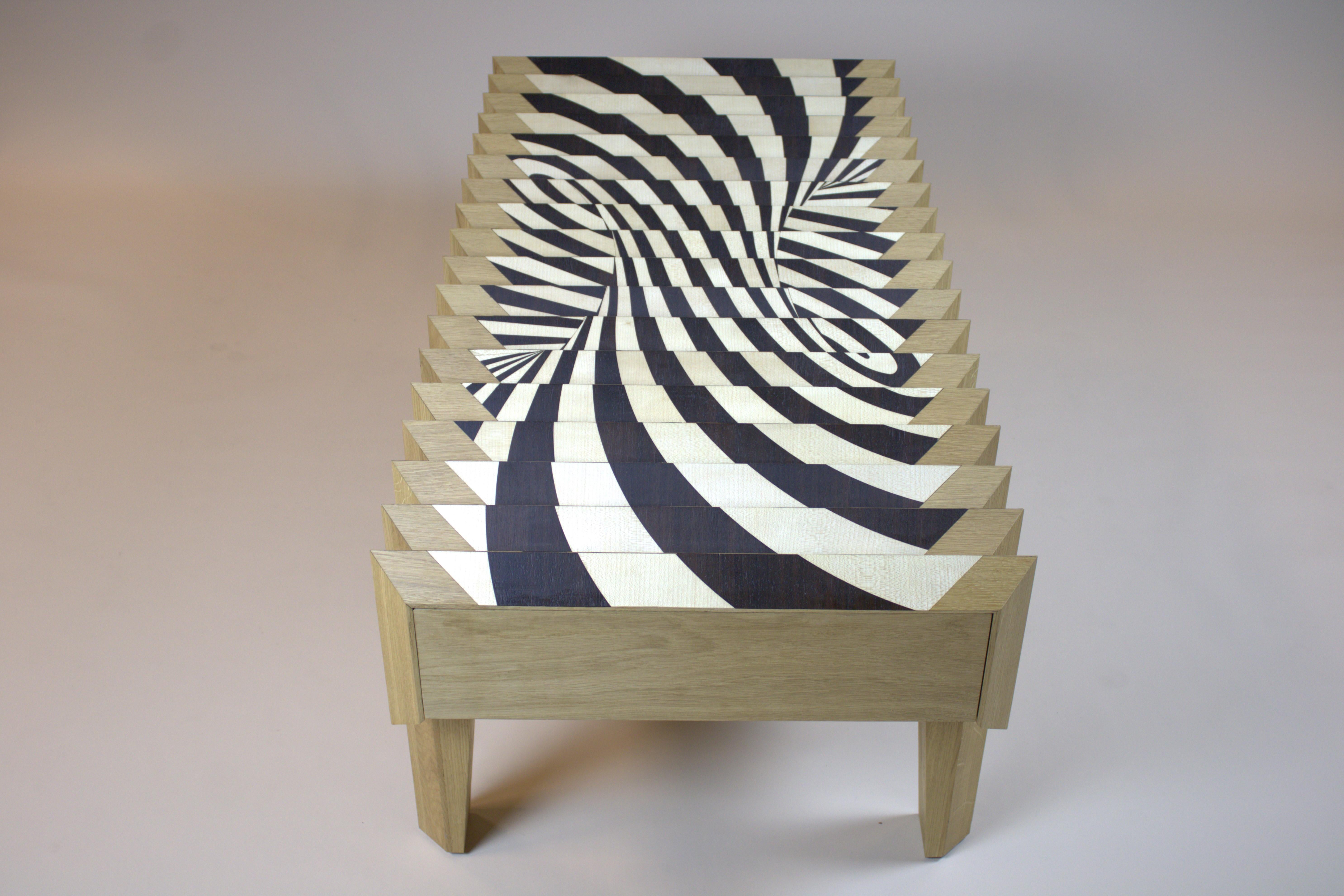 One of a kind. No reproduction. The Tavolo in Metamorfosi is a coffee table which consists of a top of triangles with a specially processed glass plate on top. If you look over the table on the short sides, you will see a 3D cube pattern and another