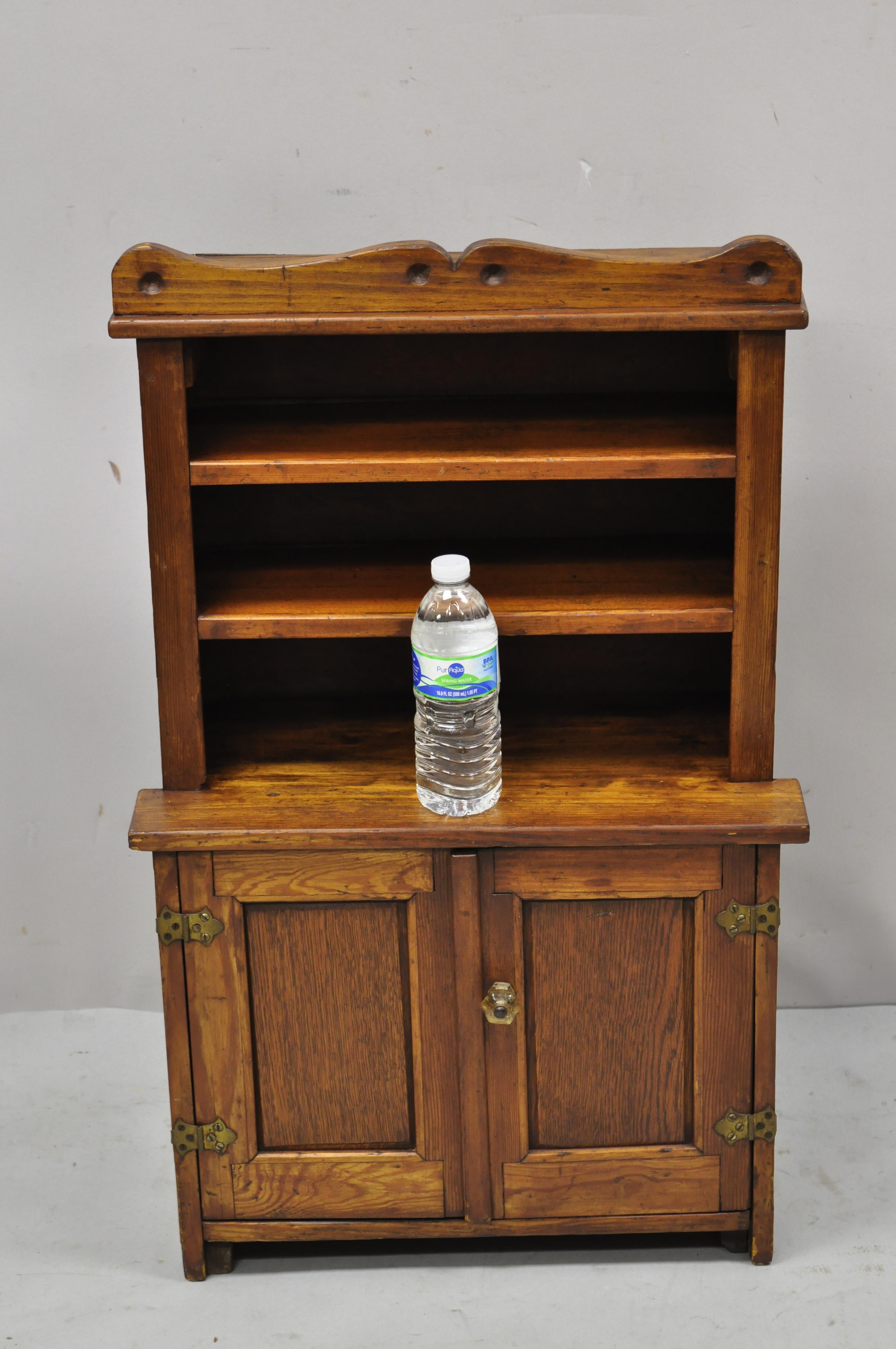 Antique oak wood small miniature cupboard colonial kitchen childs cabinet. Item features glass handles, solid oak wood construction, beautiful wood grain, very nice antique item, quality American craftsmanship. Circa early 1900s. Measurements: 32.5