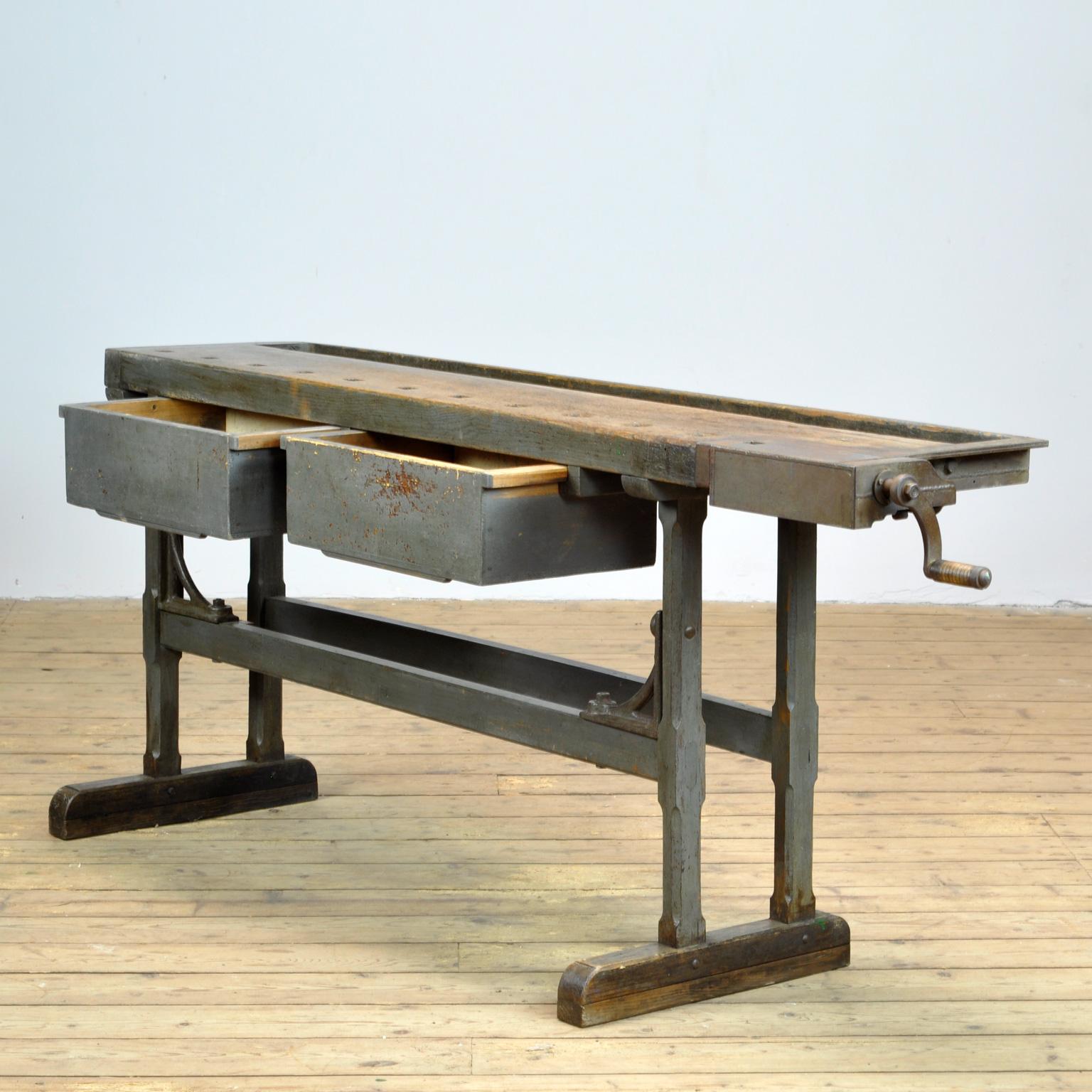 This antique workbench has a built-in iron vise and a recessed tray where the carpenter would put his tools. It was made circa 1920. Made of oak ans iron. With beautiful iron details. Very nice vintage condition.