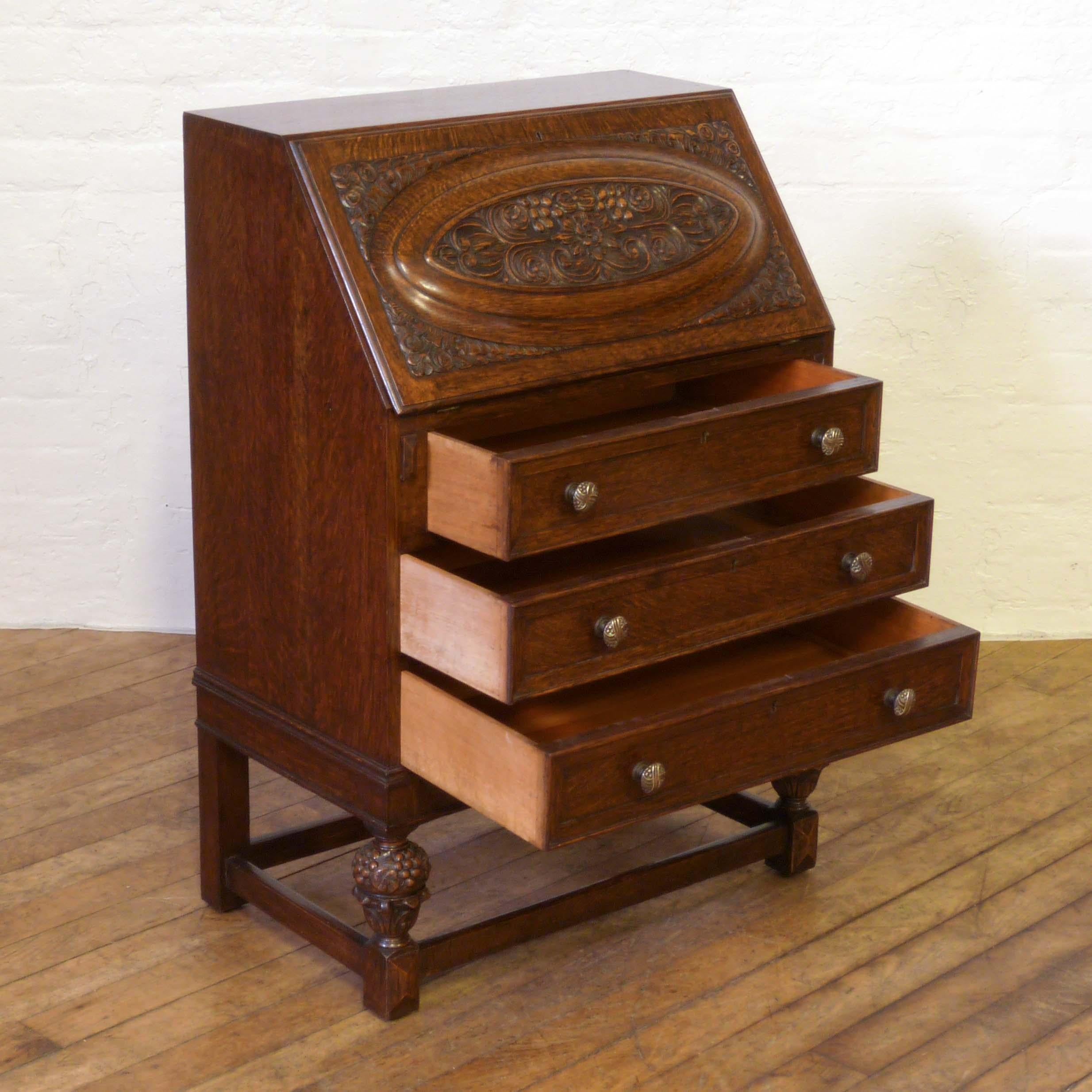 A good solid oak bureau from the 1920s but of above average quality. As you pull the fall down it draws out the fitted interior to the front edge (cantilever), the original leather writing surface is still in good order. The bureau has attractive