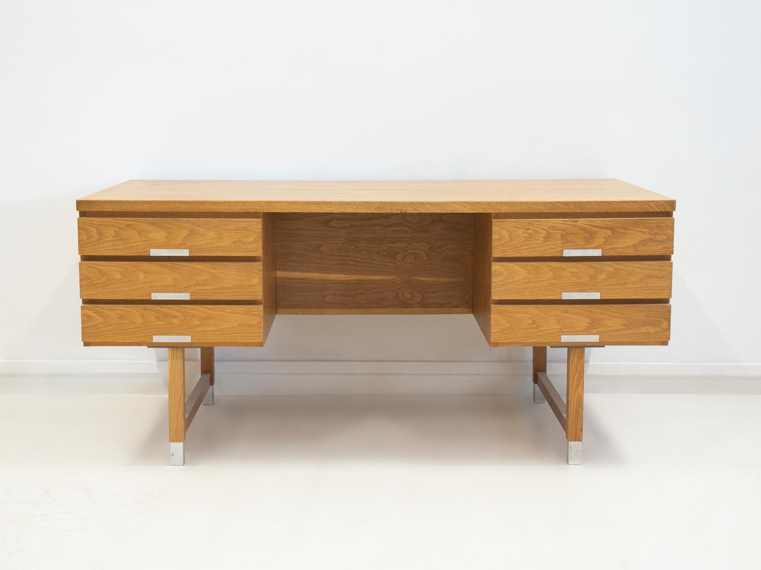 Freestanding desk, model EP 401, with veneered oak frame and table top. Front with six drawers with aluminum handles, back with three open compartments, legs with aluminum shoes. Manufactured in Denmark in the 1960's. 
Restored, but some marks on