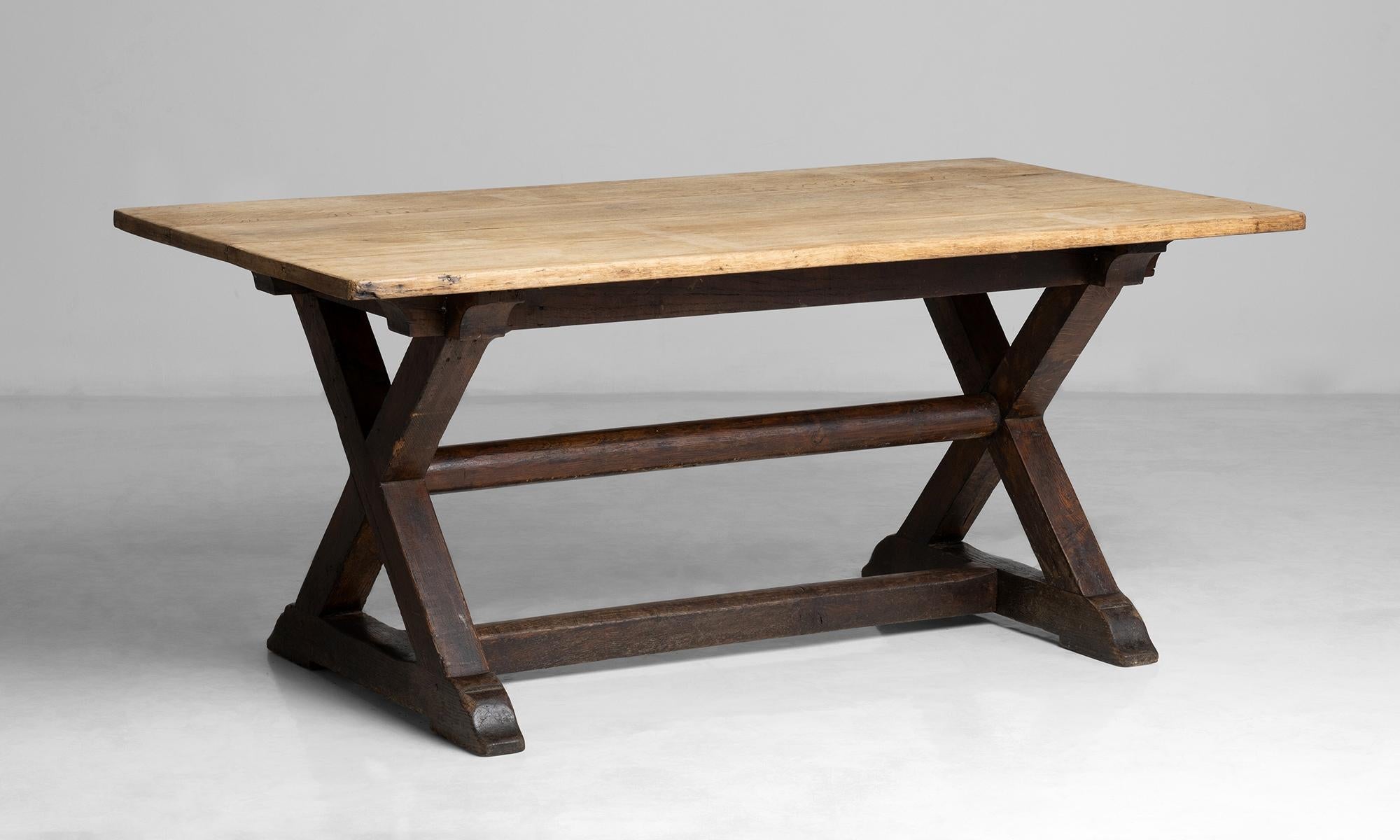 Oak X-frame table.

England circa 1890.

Constructed in oak with dark finish to base and scrubbed top.

Measures: 66”L x 35.5”D x 29”H.
 