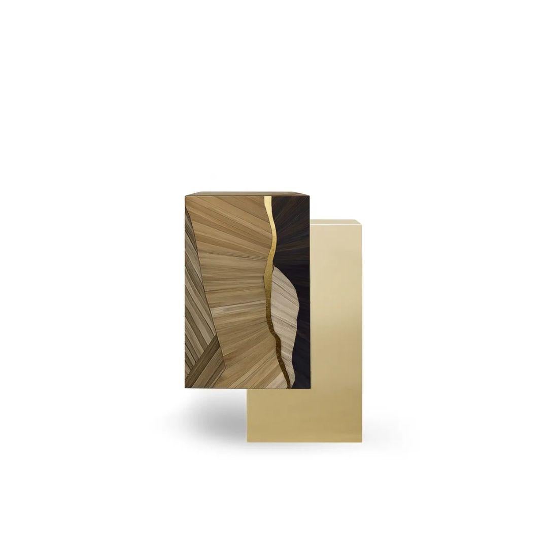 The Oasis Straw Side Table by KOKET pairs asymmetrical form with luxurious materials—featuring stacked blocks in matte brass and straw marquetry, accented by shimmering gold leaf. A striking yet refined piece for contemporary interiors.

As