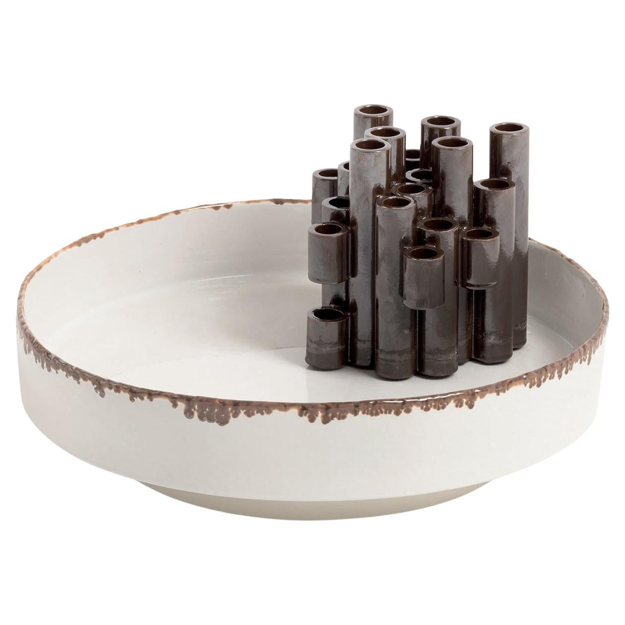 The Oatrue ceramics centerpiece features an integrated cluster of vertical holders designed to accommodate floral stems, inspired by the Japanese art of ikebana. Its shallow, rounded base with textured edging provides a contrasting platform for