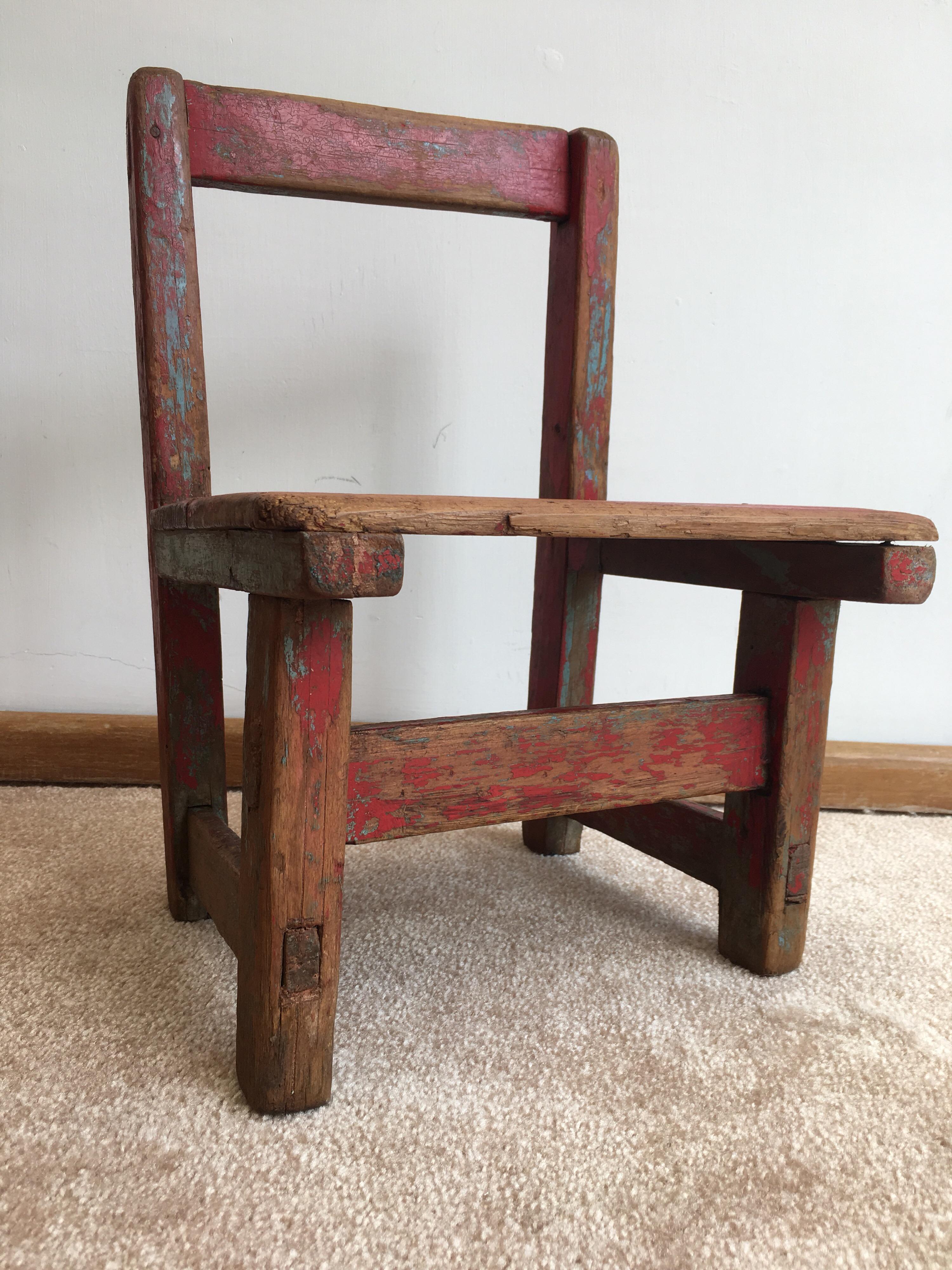 Rustic wooden chair from Oaxaca with original paint, circa 1960s. Made for a small child.