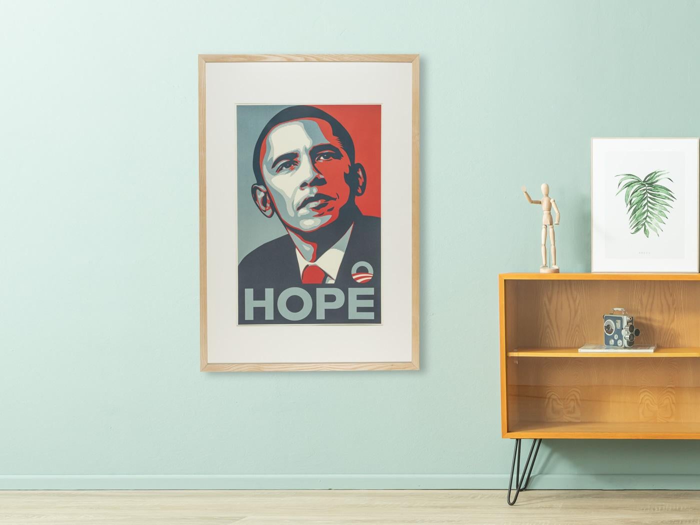 Original election poster from Barack Obama’s 2008 presidential campaign based on the iconic design by American street artist Shepard Fairey. Ready to hang. framed with a passepartout in a handcrafted ash wood picture frame behind anti-reflective