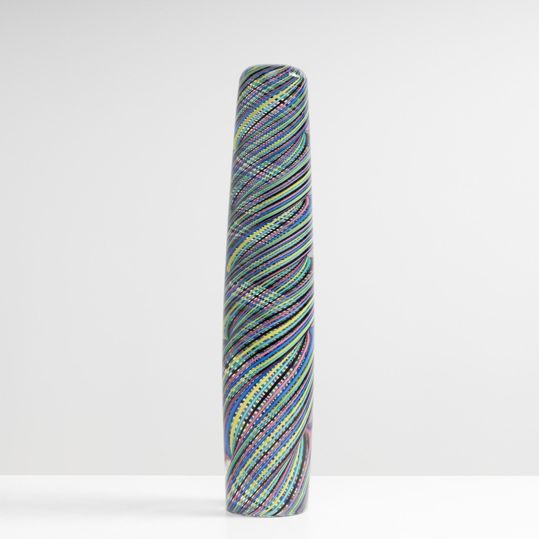 Murano Glass obelisk by Paolo Venini, Venini Murano Italy (Founded in 1921).
Clear glass obelisk.
Inclusion of “ballottino multicolore” decoration. (decoration of twisted multicolored canes).
Referenced in the Venini archives under number 4295.
Lit.