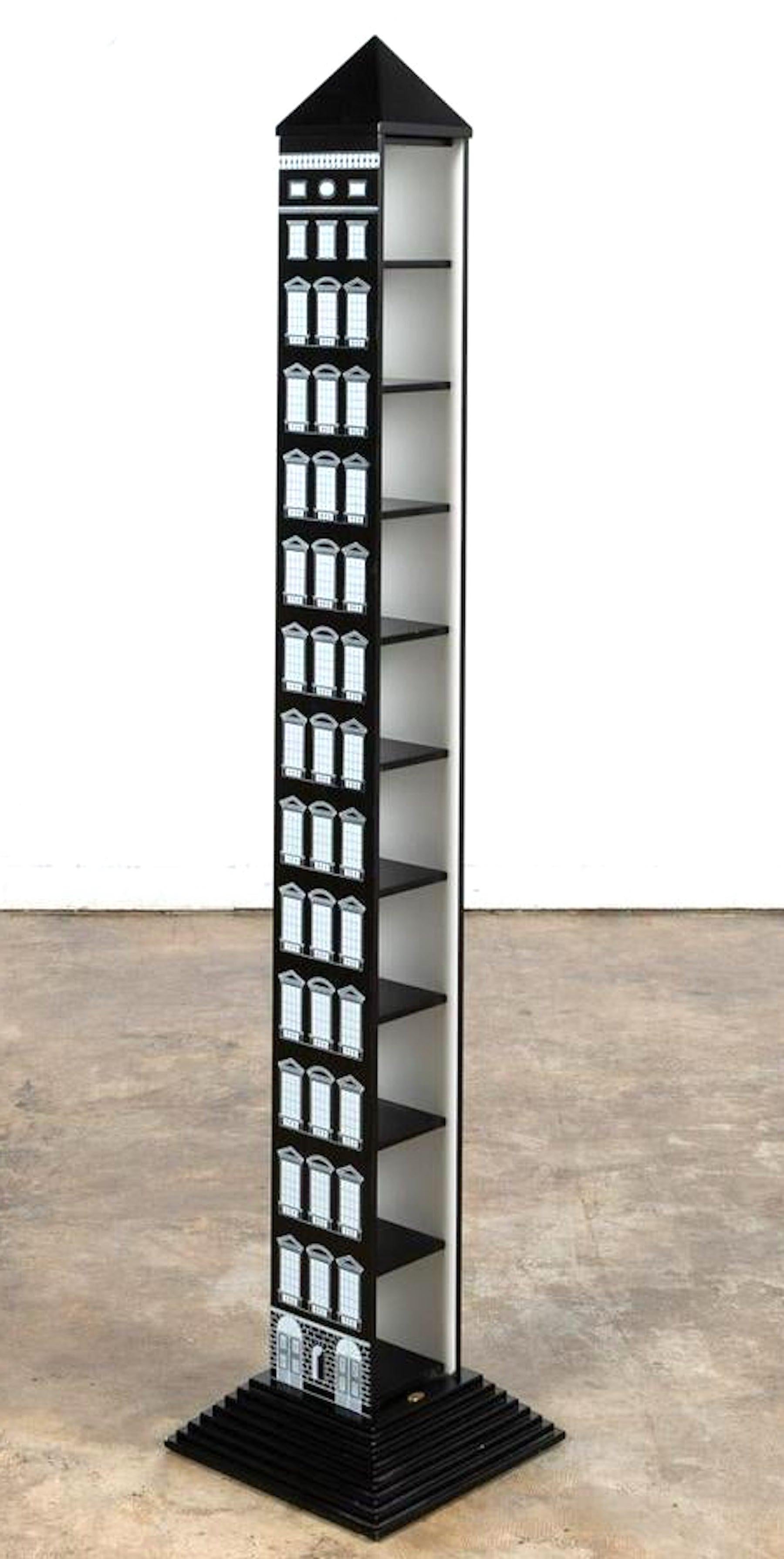 Obelisk étagère/ shelf 'Architettura' by Fornasetti, large scale with one side open fitted with ten shelves, each measuring 5-inches deep x 5.5-inches wide x 5.5 inches high, Decorated on three sides with over 120 windows and doors, raised on