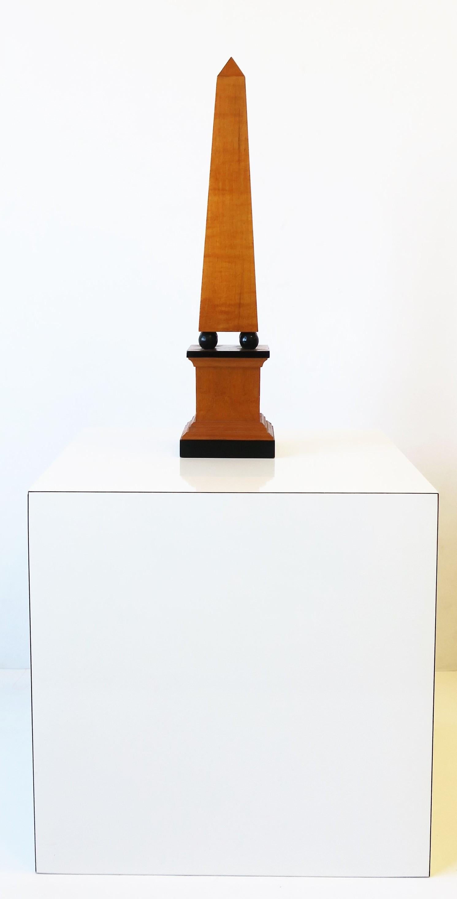 A black and brown wood obelisk, circa late-20th century. Piece is a nice height measuring 18