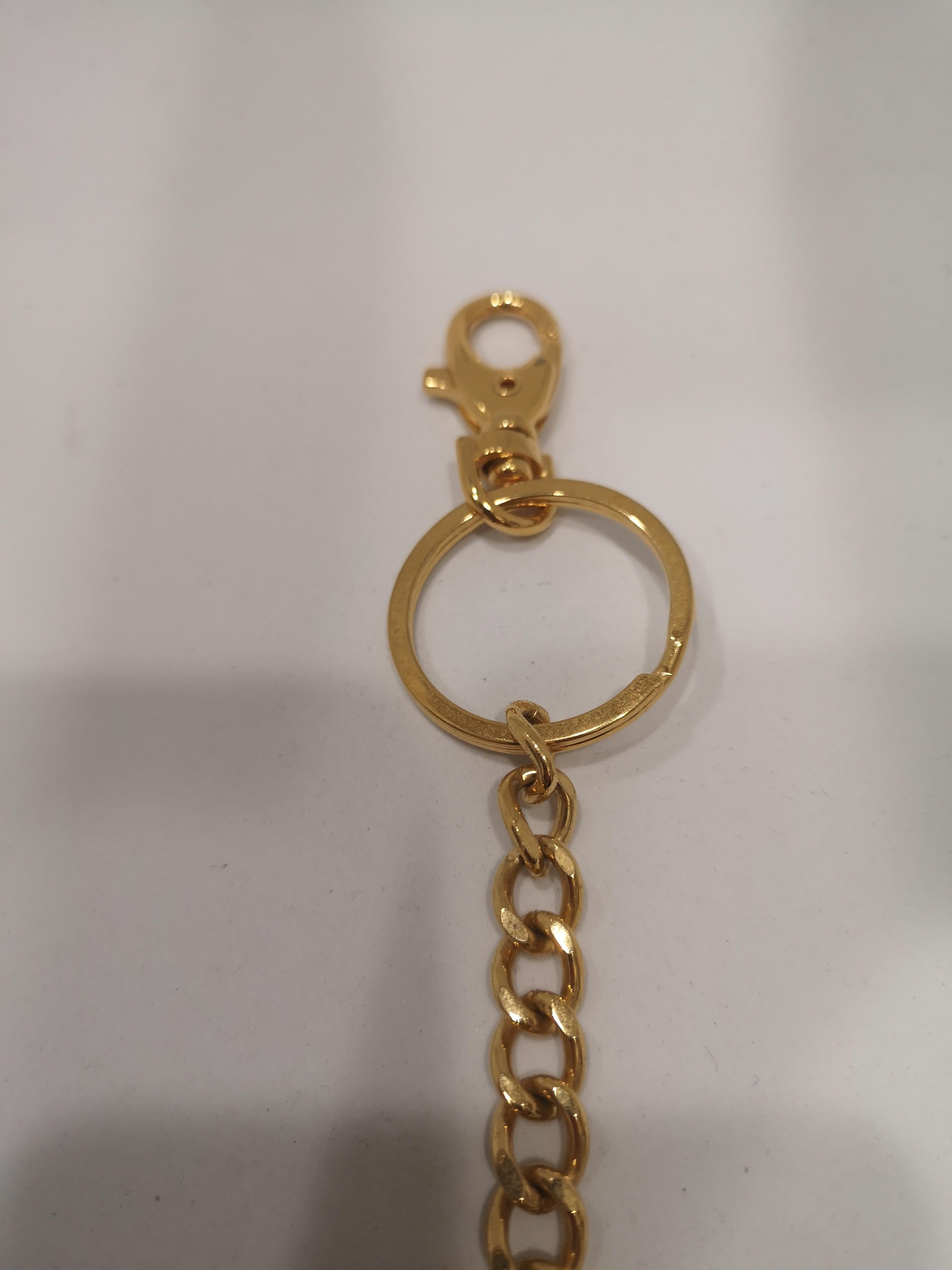 Brown Obey gold tone key chain / accessories