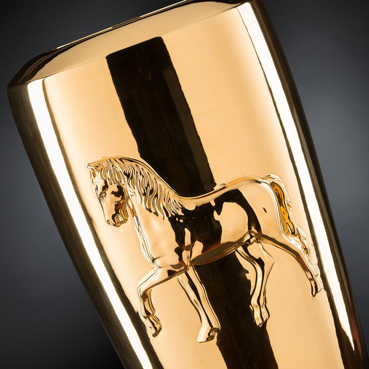 A one of a kind object of plush sophistication, this vase is distinguished for its gleaming golden color covering its entire ceramic silhouette. Masterfully handcrafted, the piece features a stunningly realistic low relief of a horse marking its