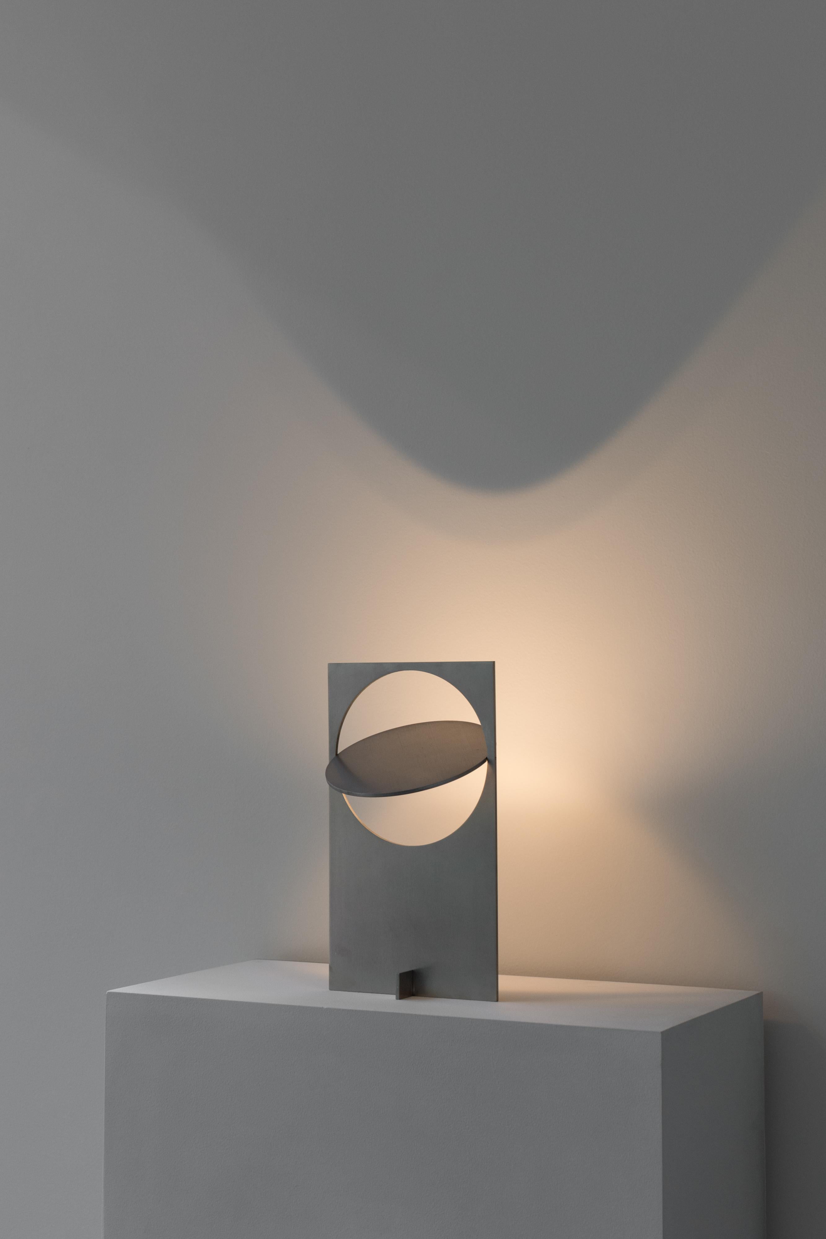 OBJ-01 stainless steel table lamp by Manu Bano
Dimensions: H 38 x W 22 x D 7 cm
Material: stainless steel

All lamps are wired for the US, but voltage converter is available for other countries. 

OBJ-01 is an understandable simple gesture, an