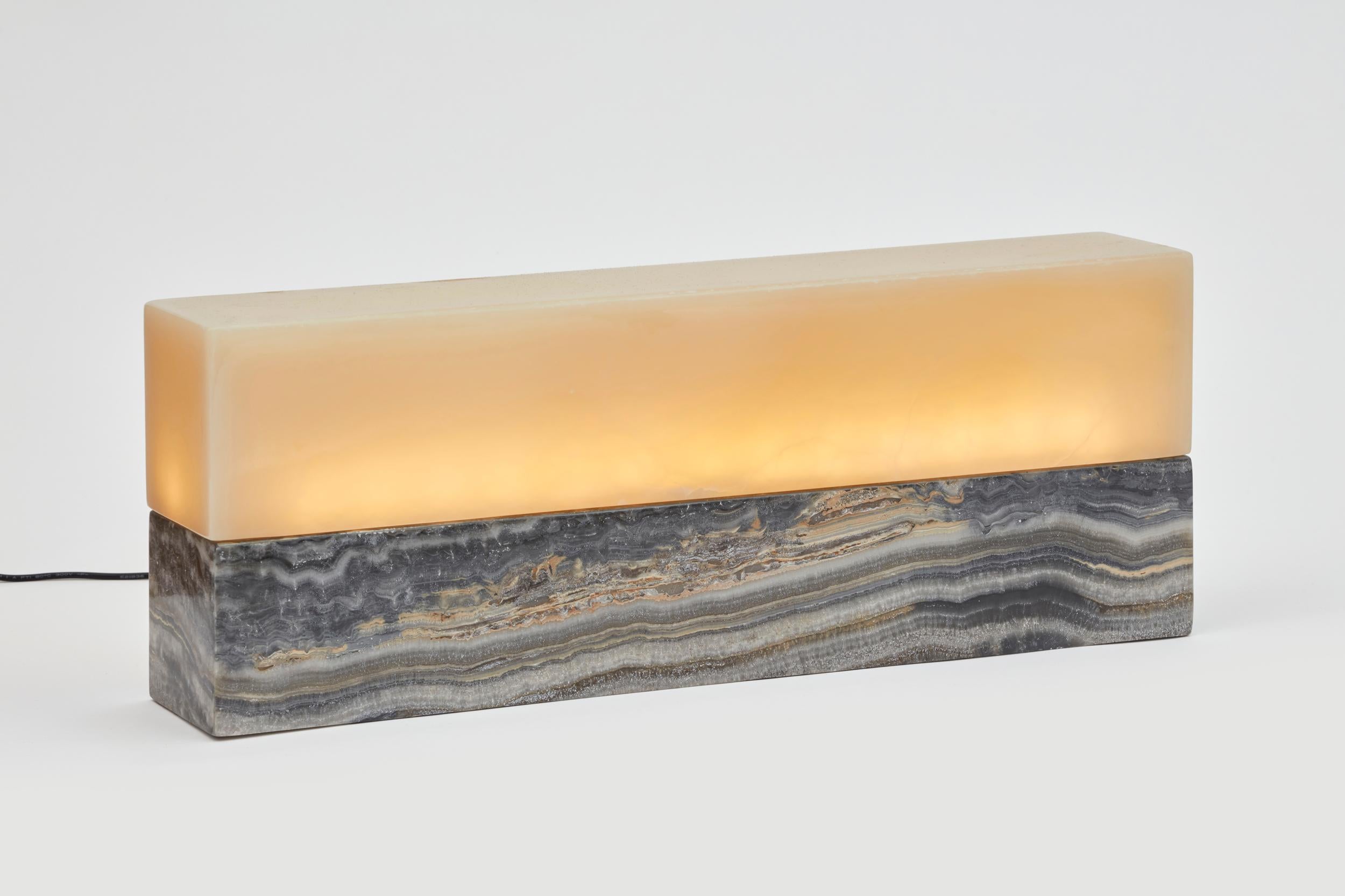 Objects of light N°5 by Estudio Rafael Freyre
Dimensions: W 51 x D 10 x H 19 cm
Materials: Andes onyx stones

Objects of light have a starting point in the origin and materiality of Calcium Onyx, a cryptocrystalline variety silica with