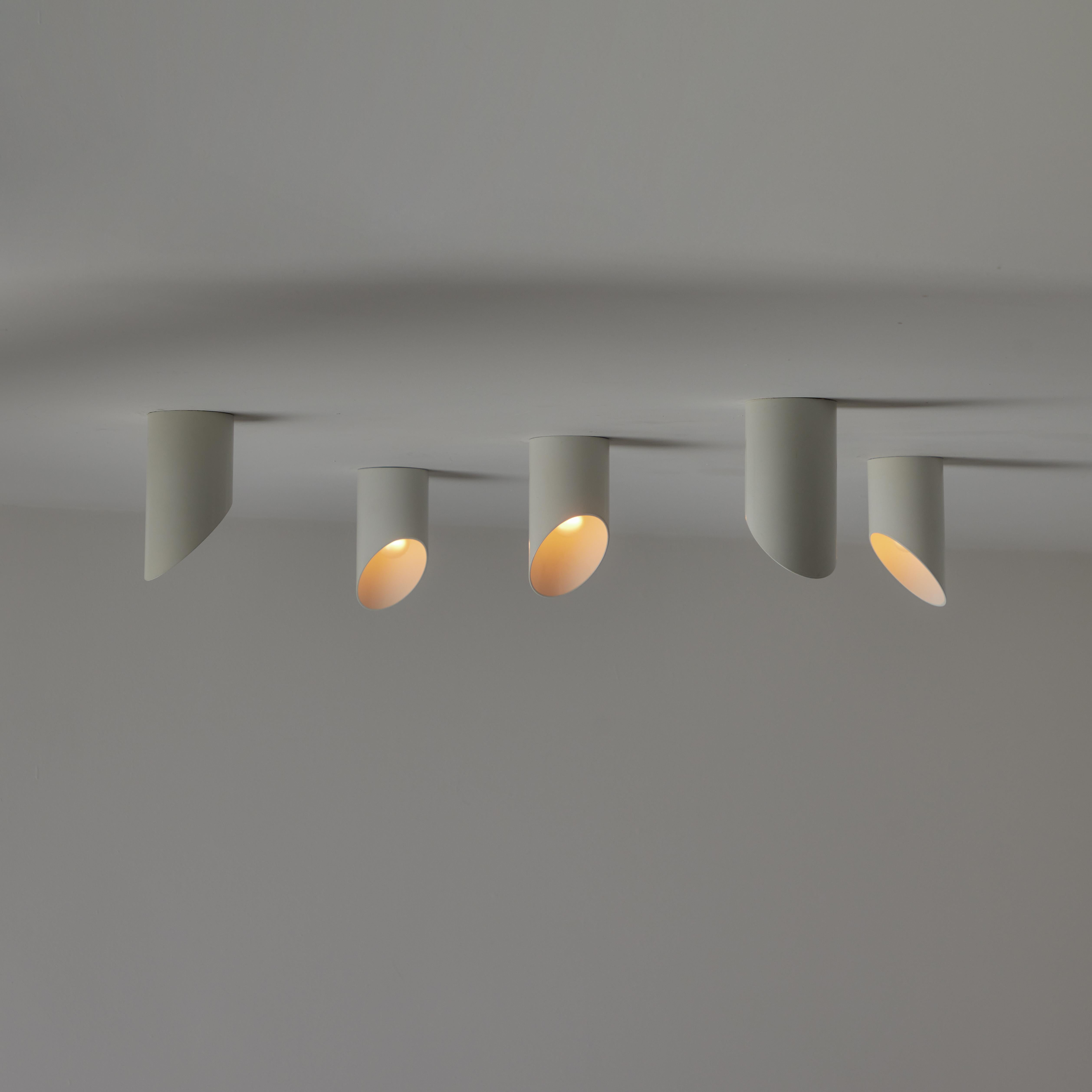 'Obliqua' Ceiling or Wall Lights by Claudio Dini for Bieffeplast. Designed and manufactured in Italy, circa the 1970s. Minimal cylinders which can be installed on either wall or ceiling. These lights have the ability to be rotated to 360 degrees to