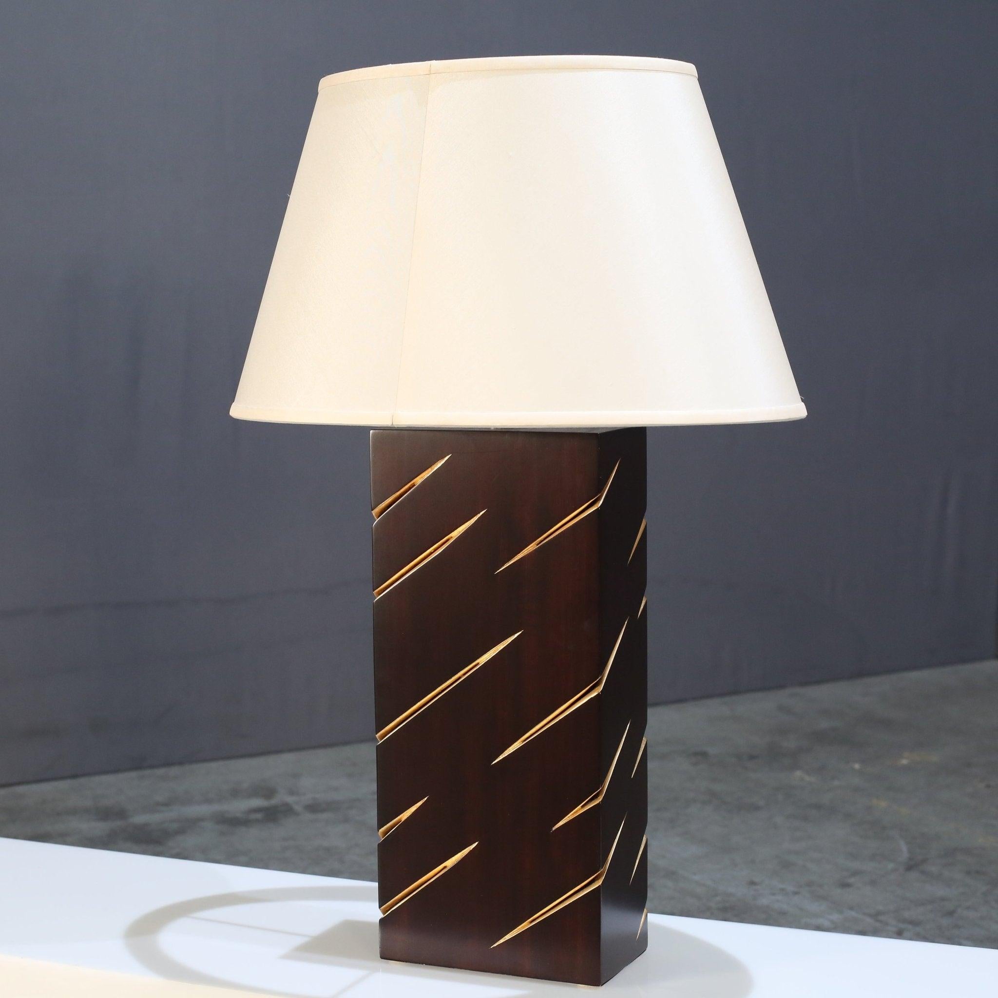 Introducing the stunning Oblique Table Lamp by renowned designer Christopher Guy. This exquisite piece features a unique and eye-catching design, with a sleek and modern silhouette that will elevate any space. Crafted with the finest materials,