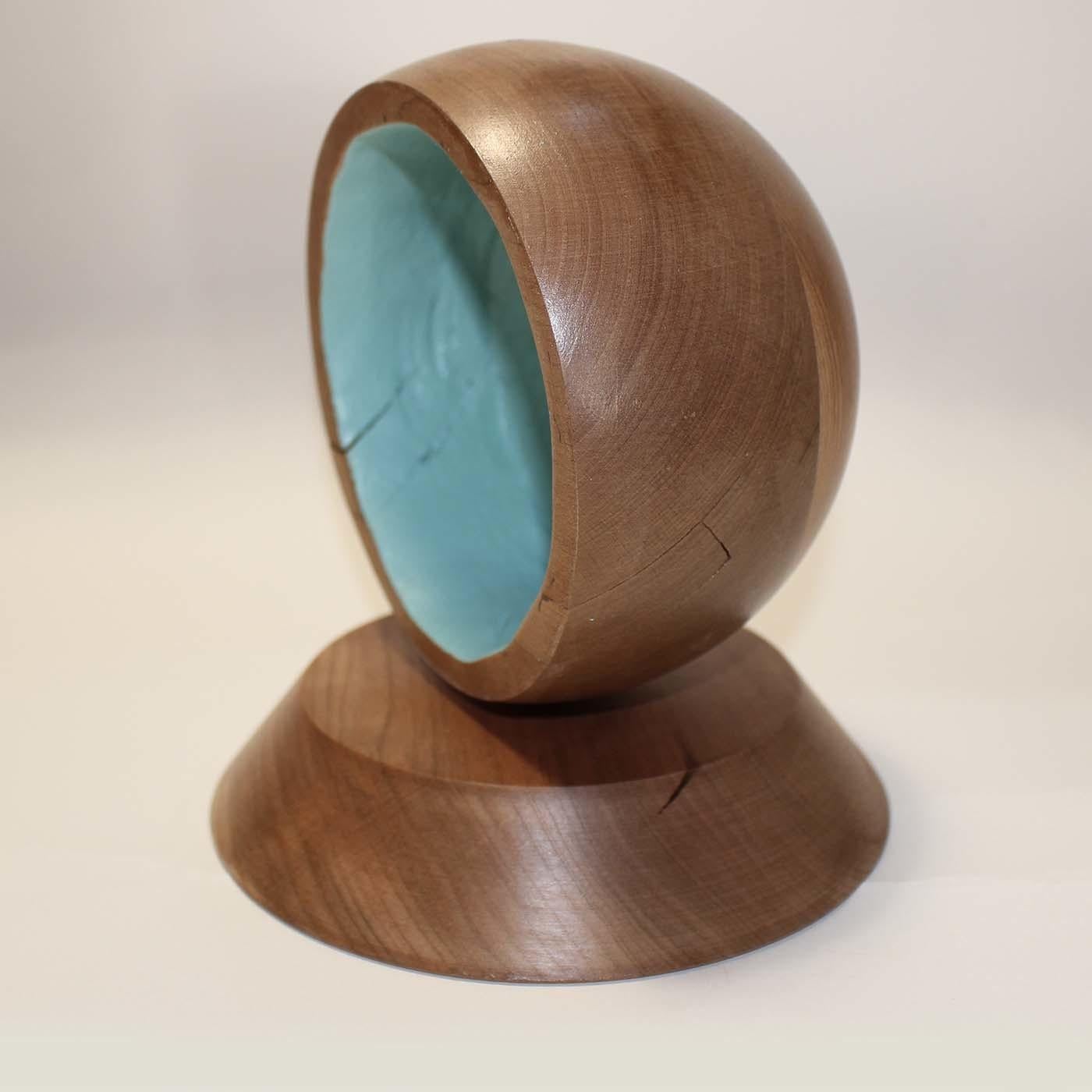 This decorative object features a half-sphere top with a truncated cone base entirely handcrafted of lathe-turned cherry. The concave section of the top is decorated by hand in vivid turquoise that adds a contrast color and a modern flair. Finished