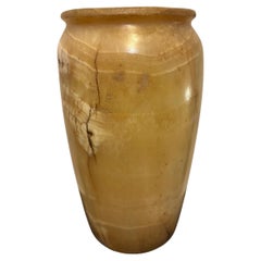 Oblong body, flat discoidal base, rimmed lip and edge, Egypt, Late Period.