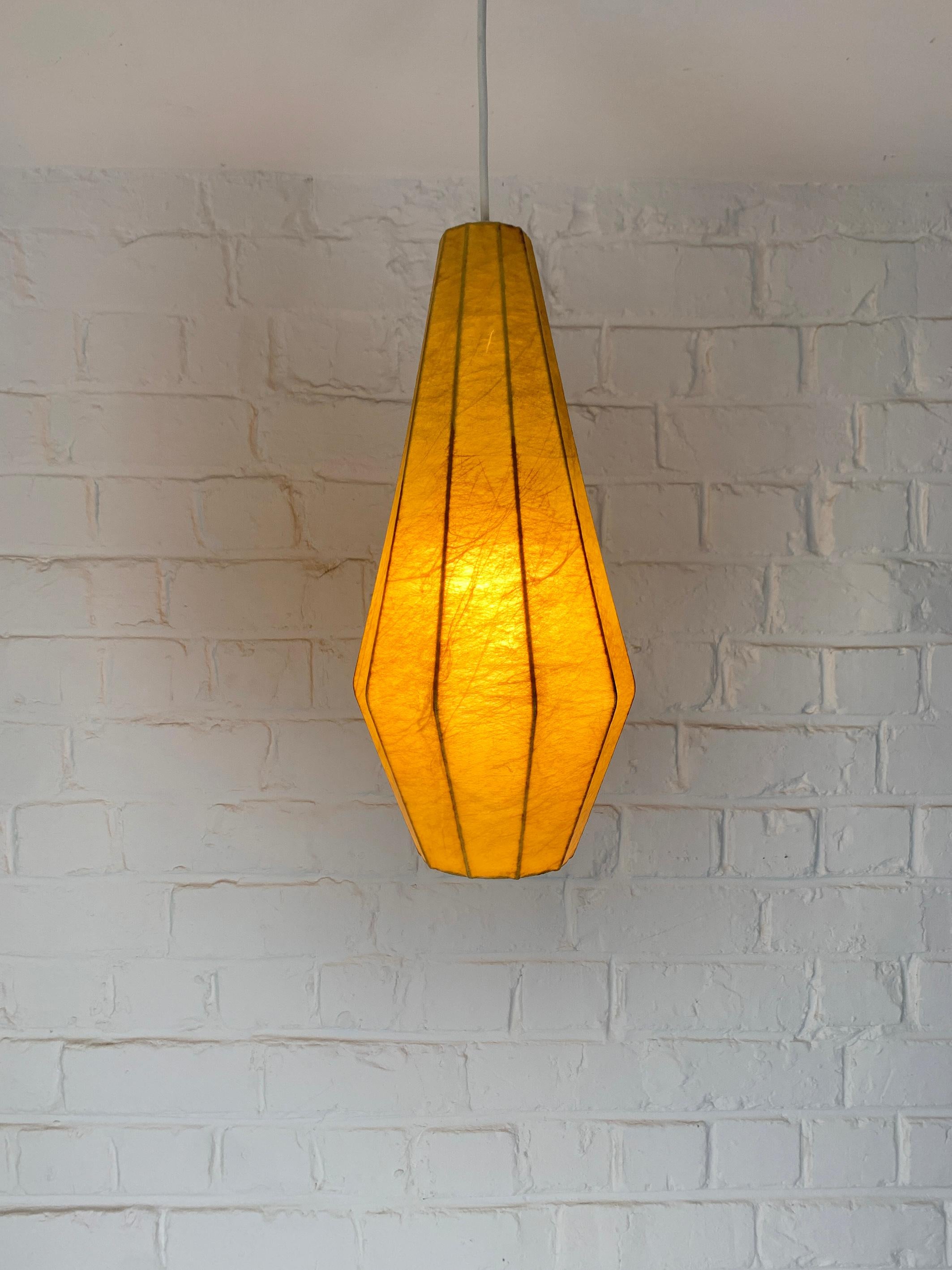Cocoon pendant lamp. Design by Friedel Wauer. Manufactured by Goldkant Leuchten, Germany in the 1960s.

A thin steel framework covered with sprayed resin, which gives a Fiberglass look. The translucent resin gives a beautiful soft light effect. 

A