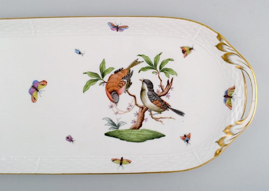 Oblong Herend Rothschild Bird serving dish / tray in hand-painted porcelain. Mid-20th century.
Measures: 49 x 17.5 cm.
In excellent condition. Micro crack in the handle from the production.
Stamped.