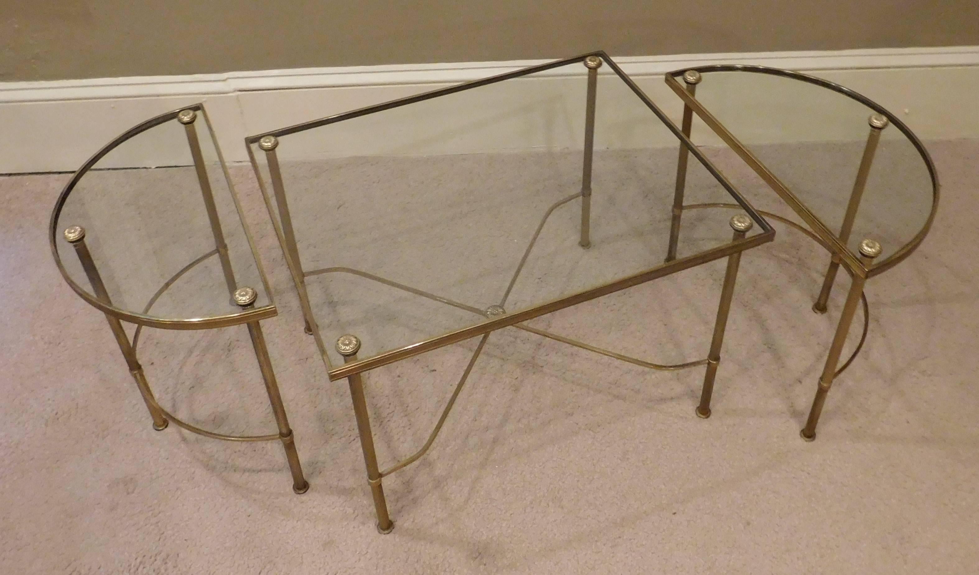 An oblong hand cast brass and glass top tripartite coffee table comprised of three independent sections. Finely-cast X-form stretchers and floral finials. End sections could be used separately as end tables - useful and handsome.