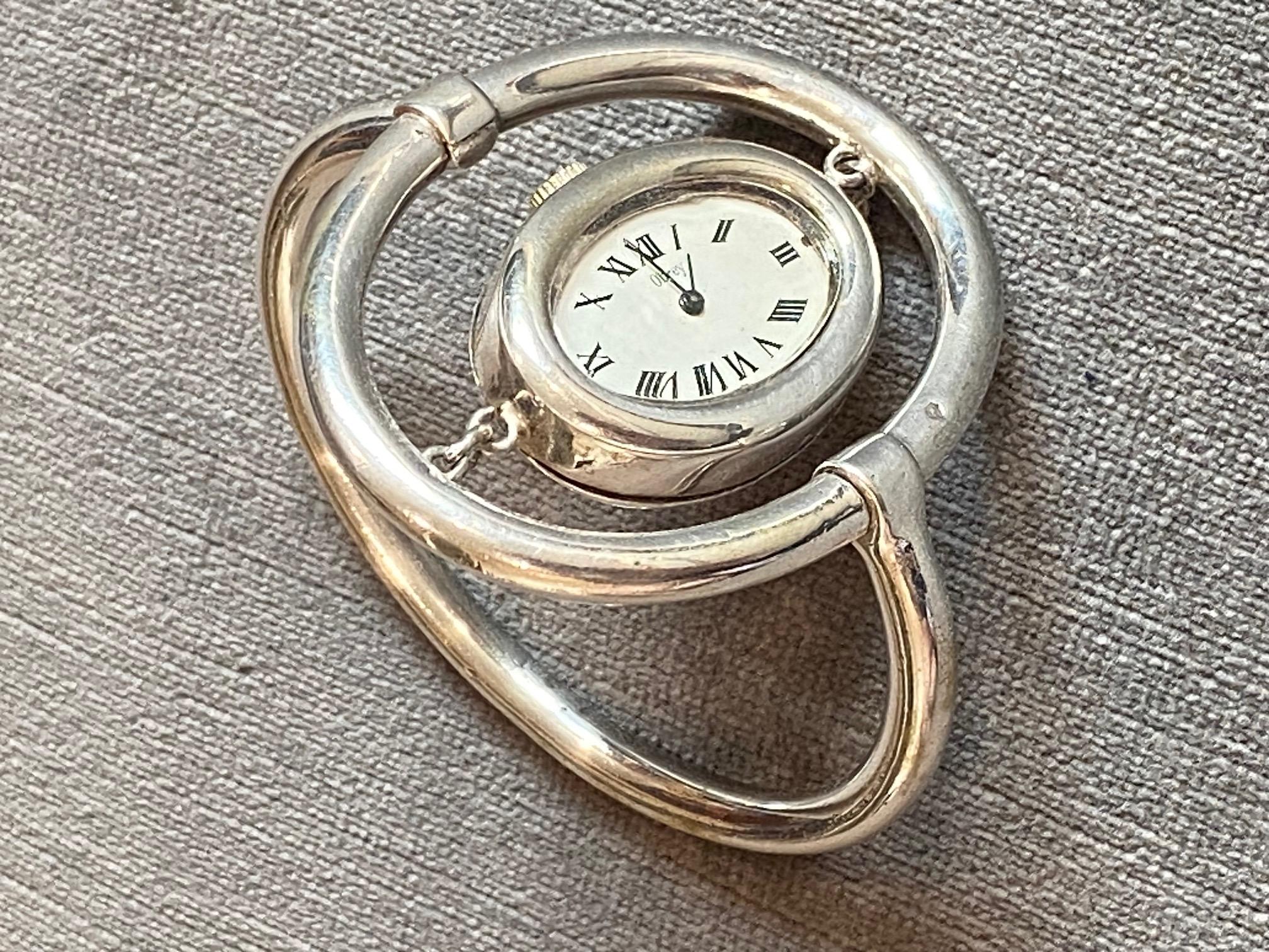 Luxury watch maker Obrey was founded in Paris in 1951 by Emile Obrey. In 1966 they launched their first collection of modernist design watches in sterling silver. 

The watch has a mechanical  or manual wind movement, oval white dial and black Roman