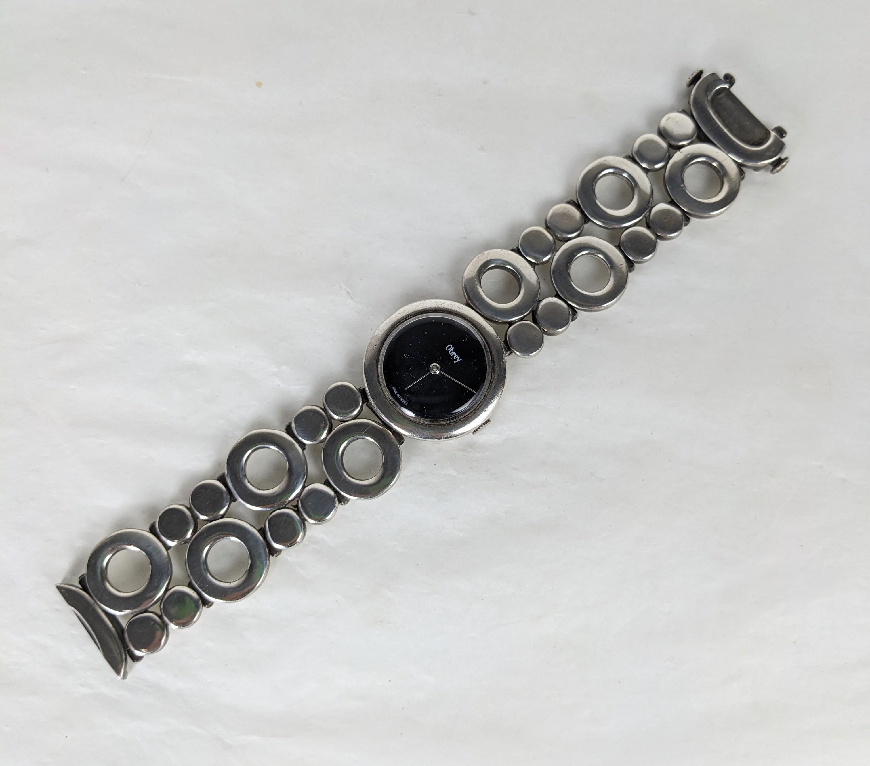 Obrey Modernist Circle Link Sterling Watch Bracelet. Le fabricant de montres de luxe Obrey a été fondé à Paris en 1951 par Emile Obrey. En 1966, ils ont lancé leur première collection de montres au design moderniste en argent sterling. Qualité