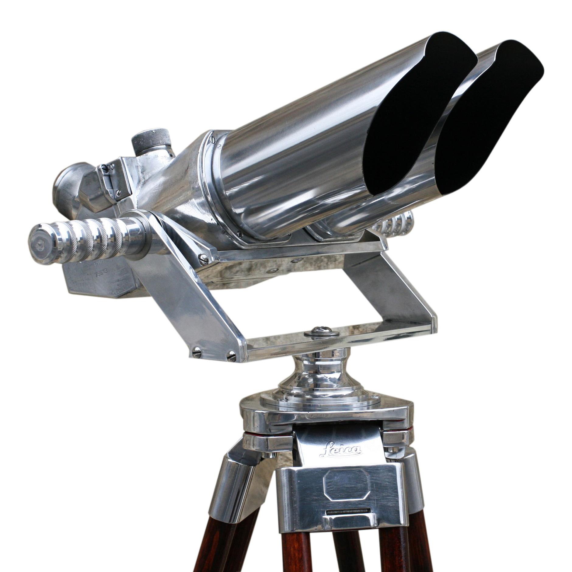 German Observation Binoculars, 10 X 80
A pair of German ex-military observation binoculars mounted on a modern aluminium cradle with vintage adjustable wooden tripod by Leica. The binoculars with 45º incline eyepieces are marked D.F. 10 x 80, X cxn