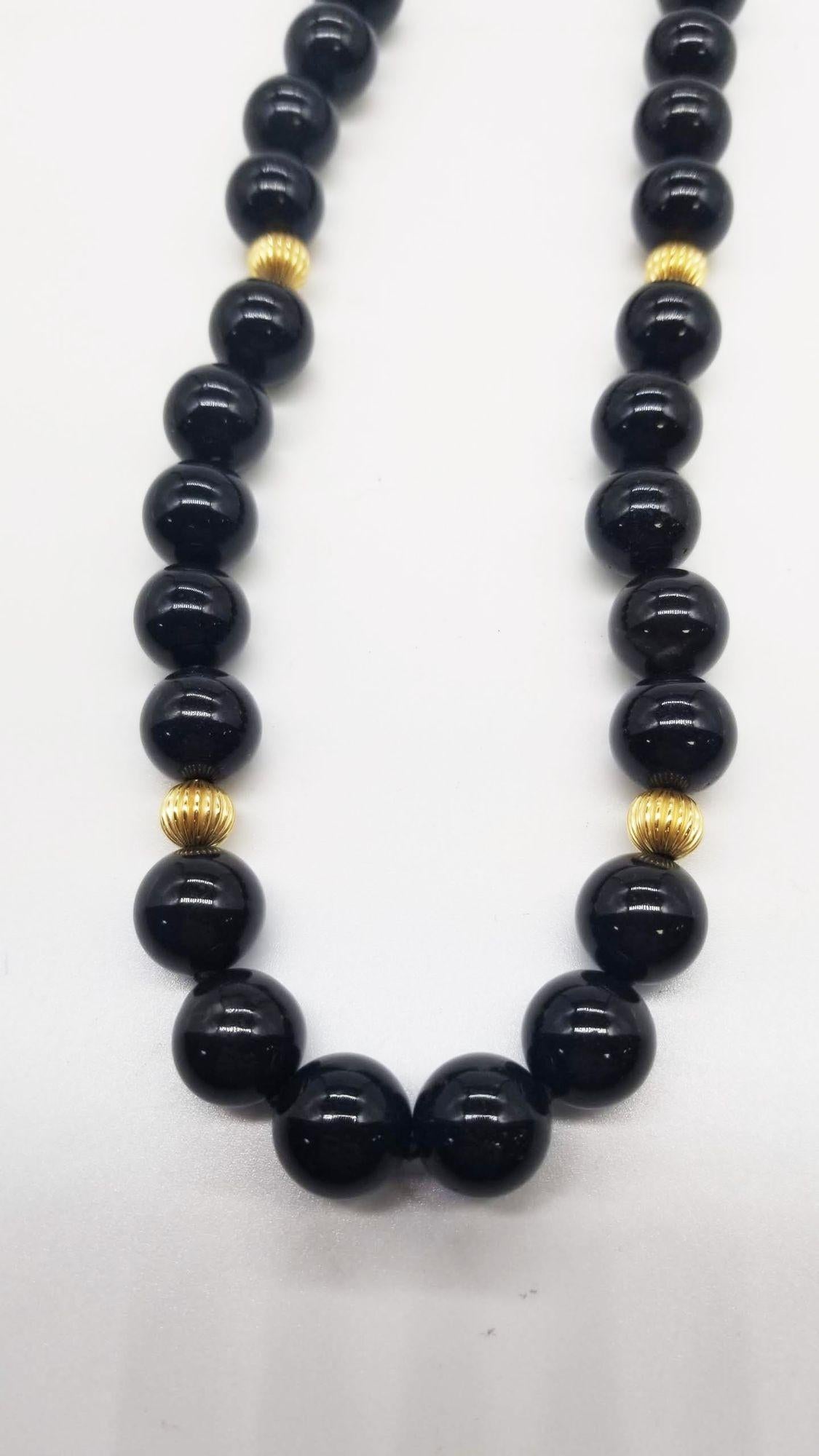 Crafted in the mid-century era, this obsidian and gold beaded necklace exudes timeless elegance. Its sleek, jet-black obsidian stones, meticulously strung together, create a sophisticated accessory. The piece encapsulates the era's allure, blending