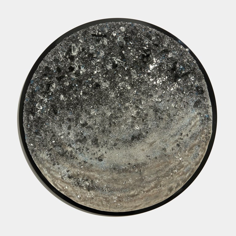 Obsidian III is a unique grey, bronze & clear glass wall-mounted artwork by the British artist Wayne Charmer.

Taken inspiration from the moment that a mass of rock is literally cracked open, to reveal a carpet of sparkling gems, Charmer presents