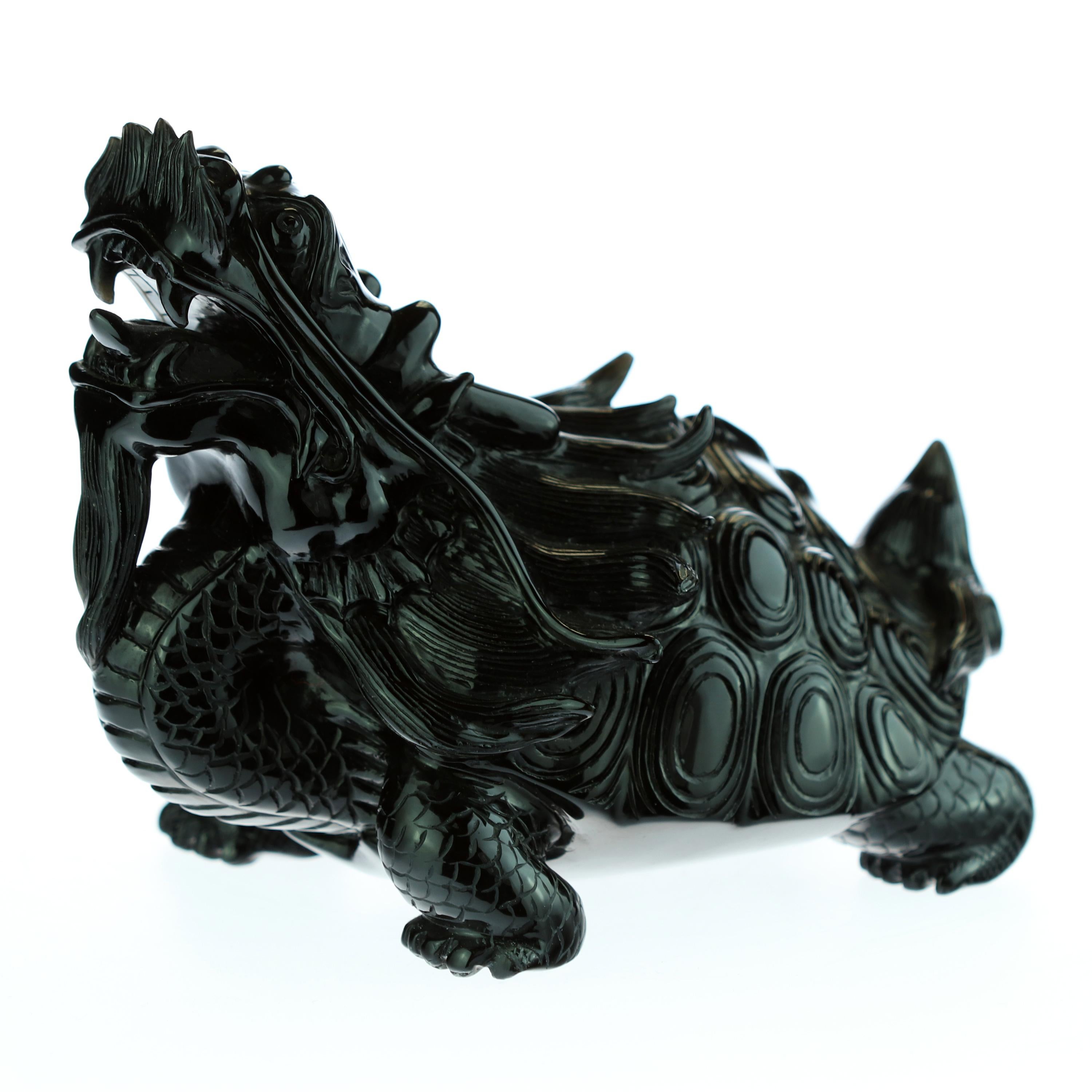 A marvelous mythological sculpture in obsidian. Chinese art, a turtle dragon creature that combines two of the four celestial animals. It had the body of a turtle and a dragon head. It symbolized courage, determination, fertility, longevity, power,