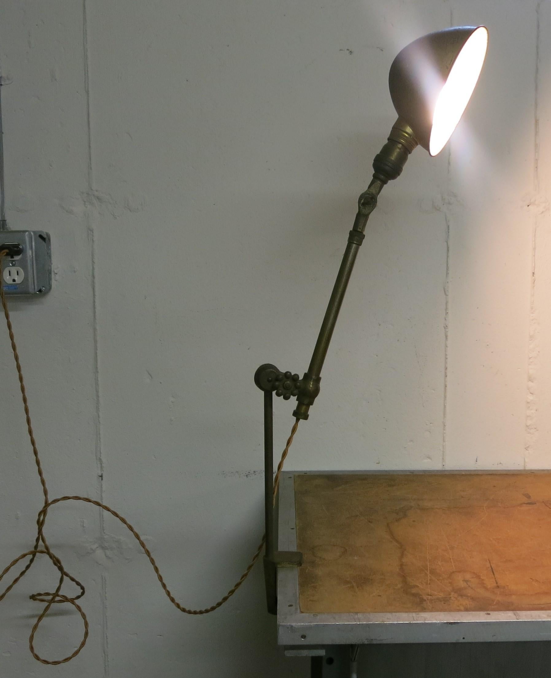 Brass O.C. White clamp on table lamp. Aged patina, and newly wired. Can adjust roughly from 34