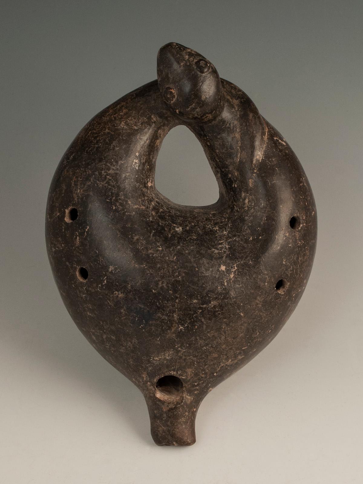 Circa 100 B.C.-250 A.D. Ocarina in the shape of a serpent, Colima, West Mexico

A wonderful ocarina in a curled serpent form with head over tail, blow hole at the back and four holes for different notes on the body. It produces rich, resonant sound