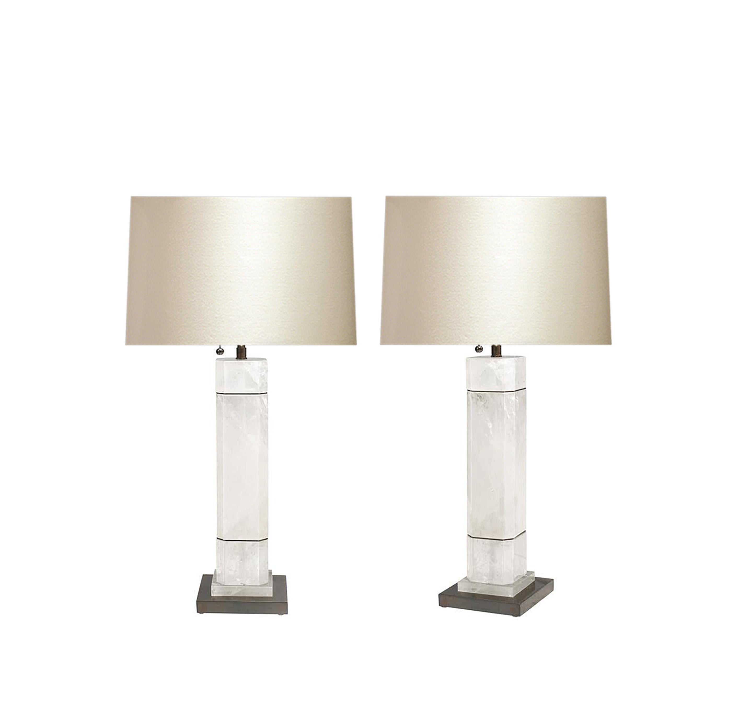 A pair of octagonal column form rock crystal quartz lamps with antique brass decoration. Created by Phoenix Gallery, NYC. 
To the top of the rock crystal: 15.5