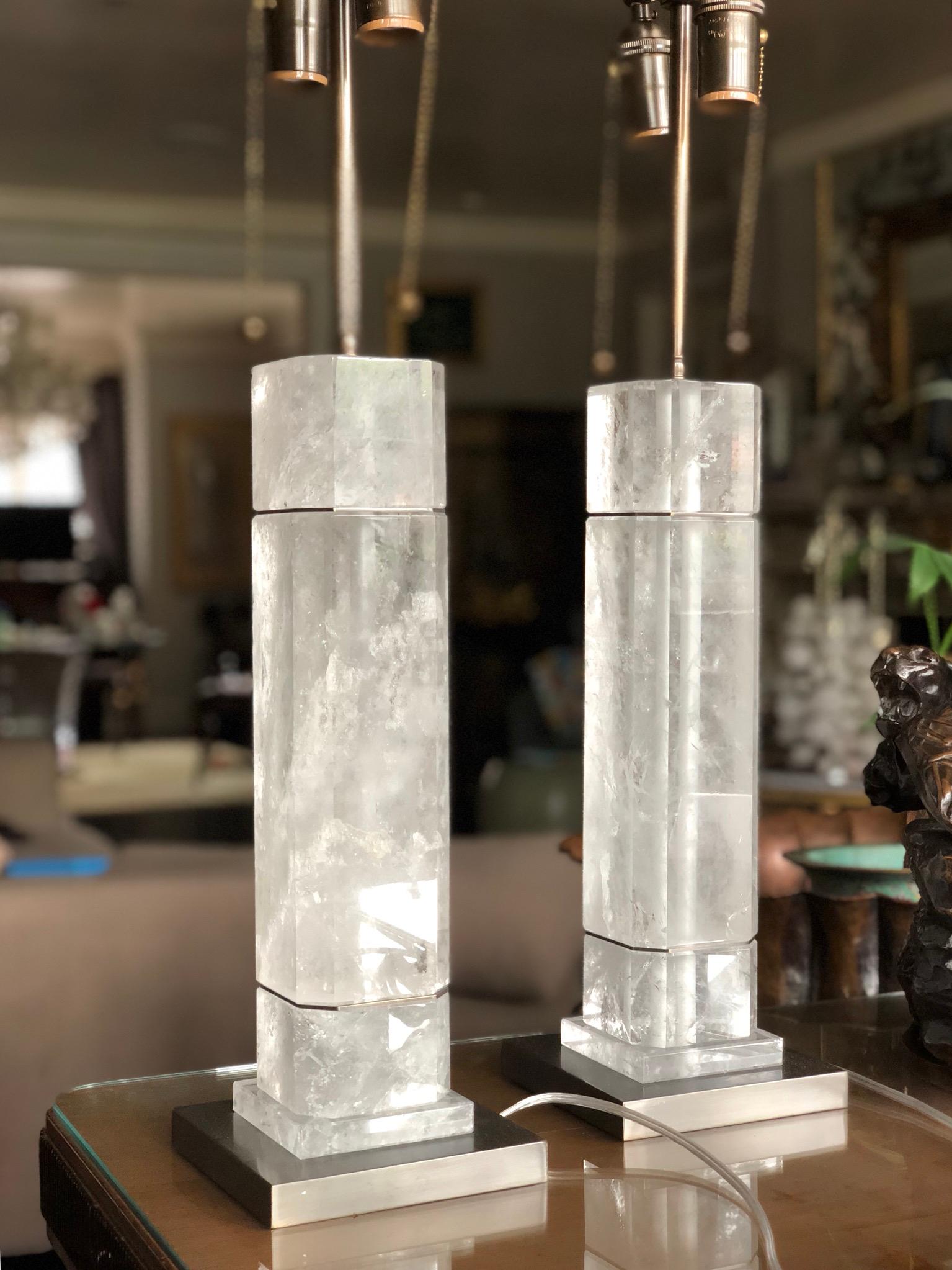A pair of octagonal column form rock crystal quartz lamps with antique brass decoration. Created by Phoenix Gallery, NYC. 
To the top of the rock crystal: 15.5