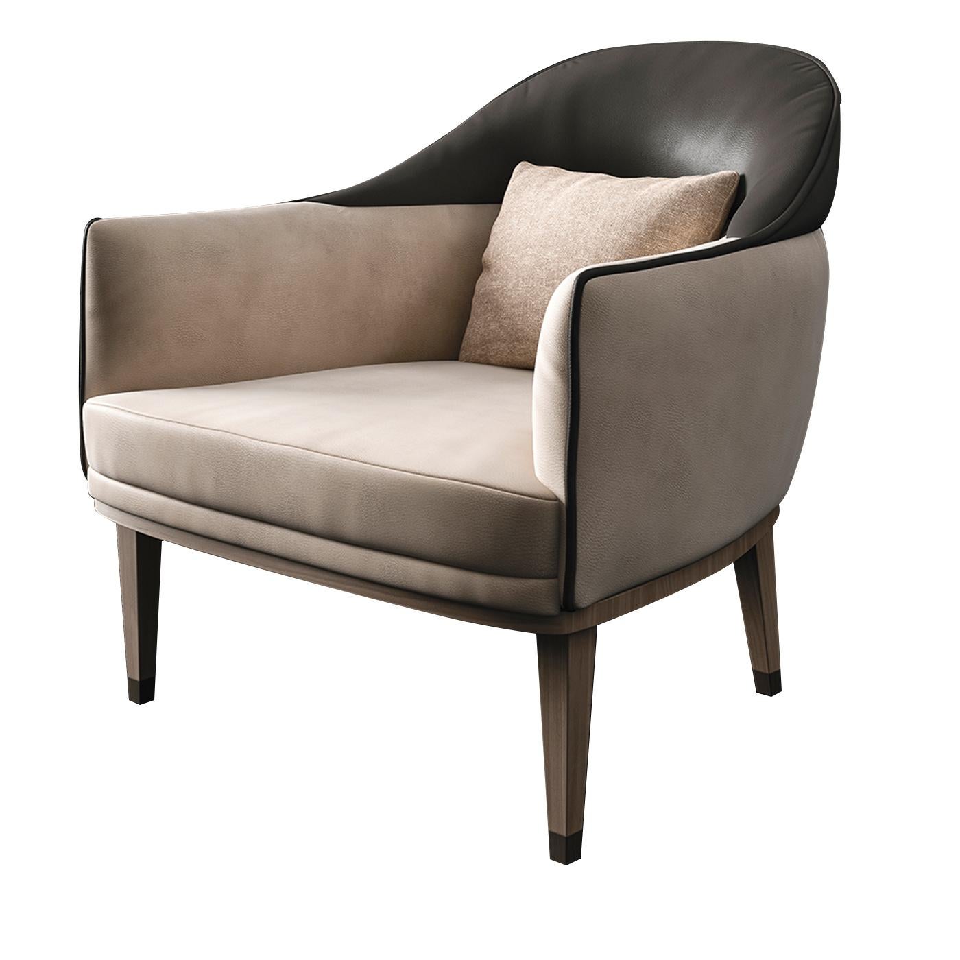 The occasional armchair has a rounded, enveloping design that provides profound comfort and relaxation. With a base crafted from wood, it features nubuck upholstery the lower half of the chair and armrests in a neutral beige and the top part of the