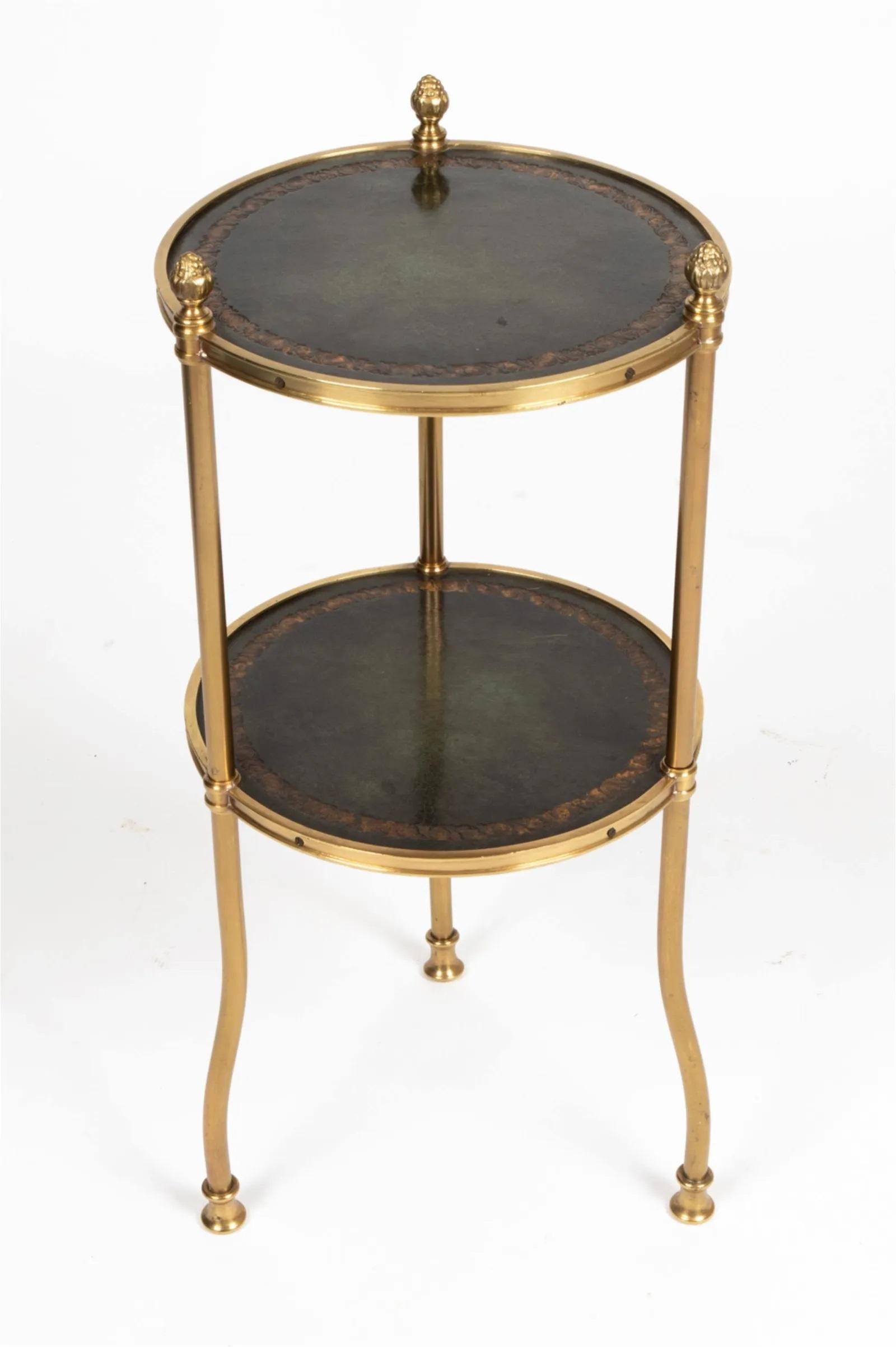 Occasional side table by Hollyhock (retailer LA - Suzanne Rheinstein), with three embossed leather-topped round tiers and curved gilt brass legs with acorn finials.  Inspired by a design by Frances Elkins for the Cypress Point Club.  Circa 1970's.