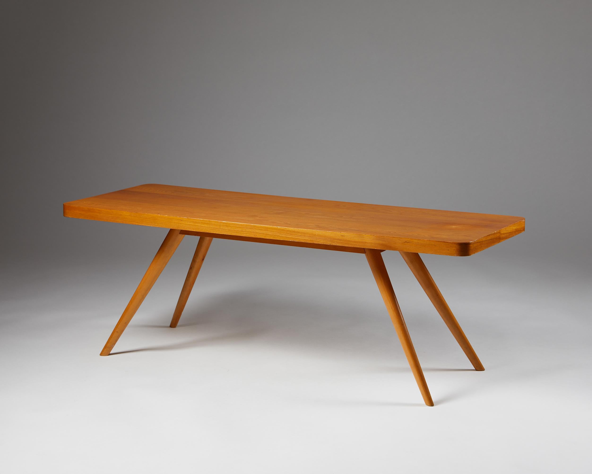 Occasional table, anonymous for Oy Stockmann AB,
Finland. 1950s.

Elm.

The most compelling aspect of this occasional table is the relationship of its legs to the surface. With splayed tapering legs, the well thought out design resembles an animal —