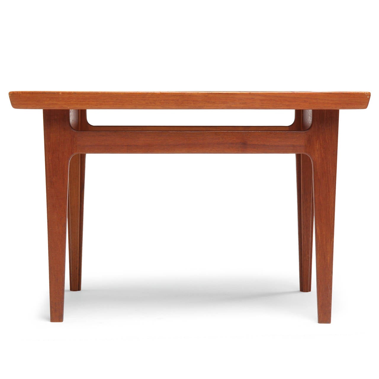 A refined and architectural Scandinavian modern occasional table designed by Finn Juhl for France & Son. Crafted from a warm teak and features a raised edged top and tapered legs. Produced in Denmark, circa 1960s.

Finn Juhl was first and foremost