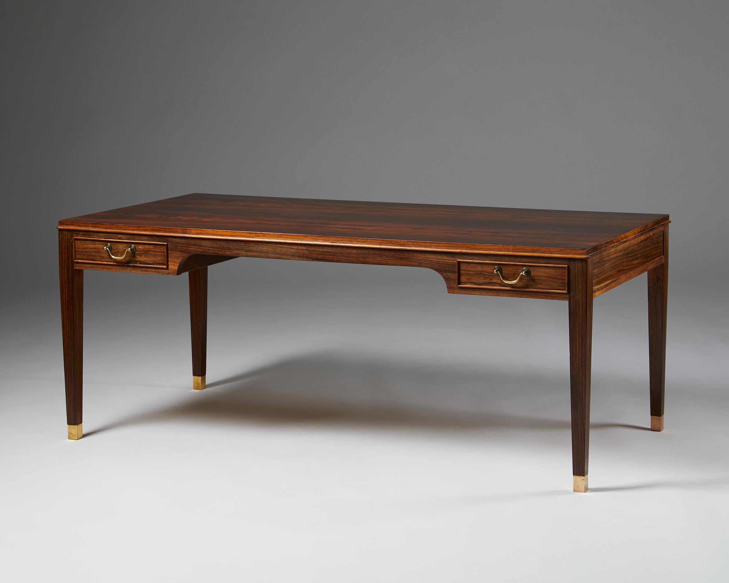 Occasional table designed by Frits Henningsen,
Denmark, 1940’s.

Rosewood with brass handles.

Dimensions:
H: 53 cm / 1’ 9 3/4”
L: 130 cm / 4’ 3 1/4”
W: 64 cm / 2' 2/3”

Henningsen became a major driver of the furniture exhibitions of the period,