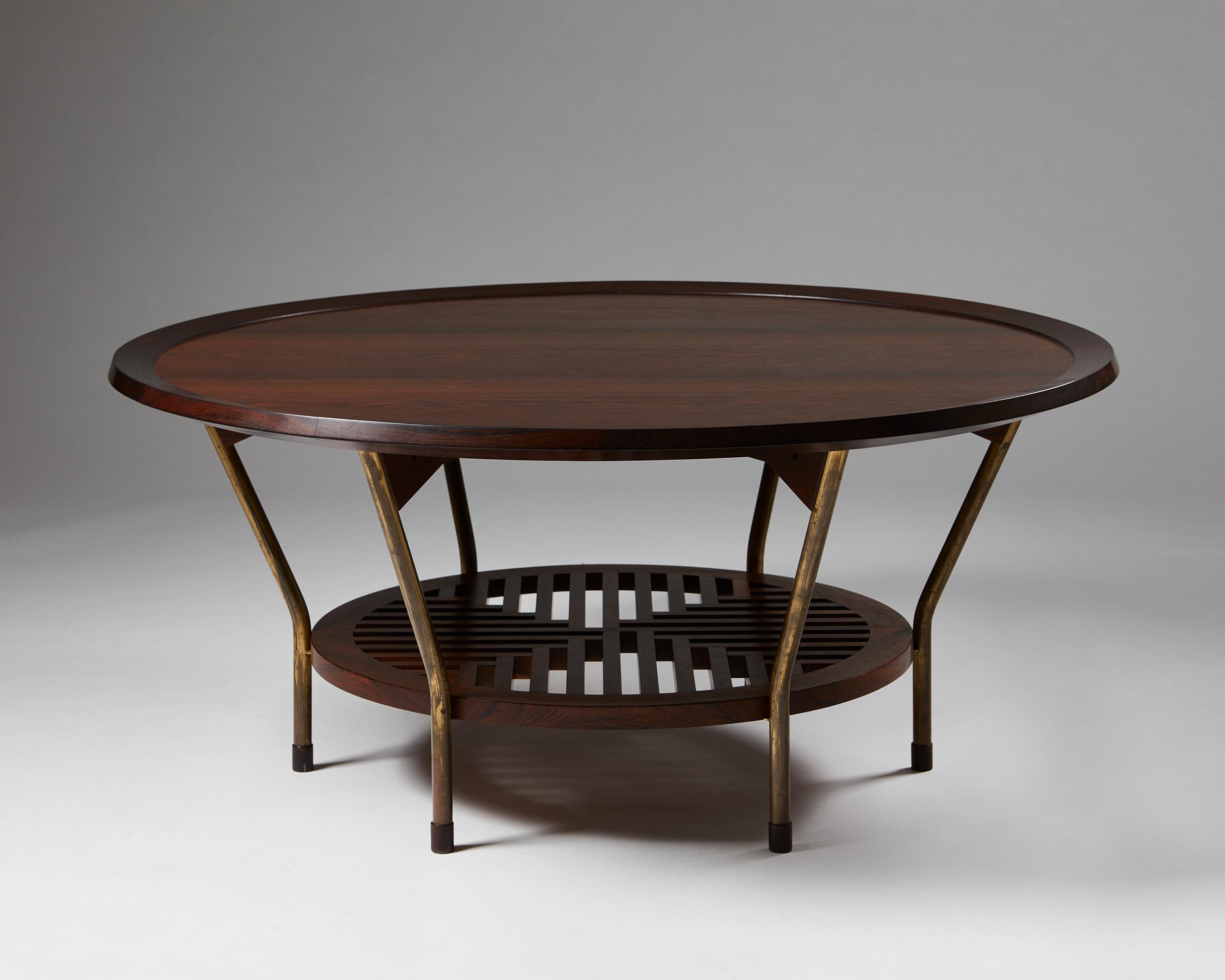 Occasional table designed by Frits Schlegel,
Denmark, 1949.

Rosewood and brass.

Unique.

Dimensions:
H: 52 cm / 1’ 8 1/2