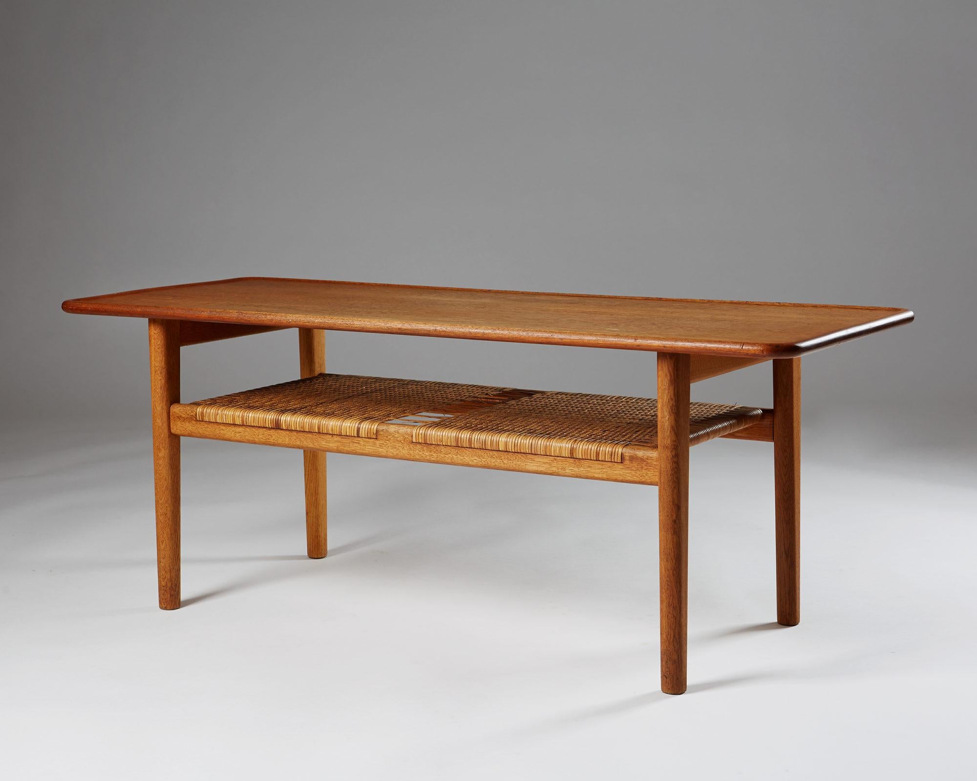 Occasional table designed by Hans Wegner for Andreas Tuck, Sweden, 1950s.
Solid teak and cane.

Measures: H: 50 cm/ 19 3/4''.
L: 130 cm/ 4' 3 1/2''.
D: 50 cm/ 19 3/4''.