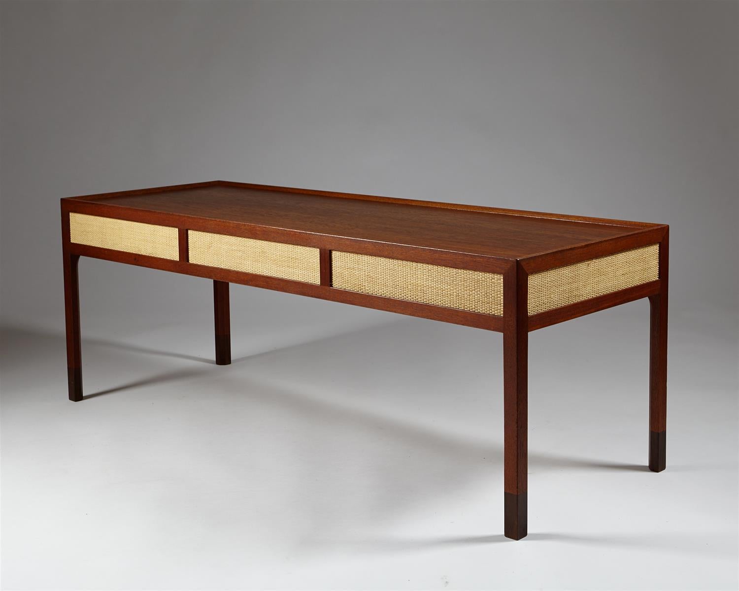 Occasional table designed by Mogens Lassen for T. Madsen,
Denmark. 1953.

Teak, rosewood and hessian.

Measurements: 
H: 55 cm / 1' 8