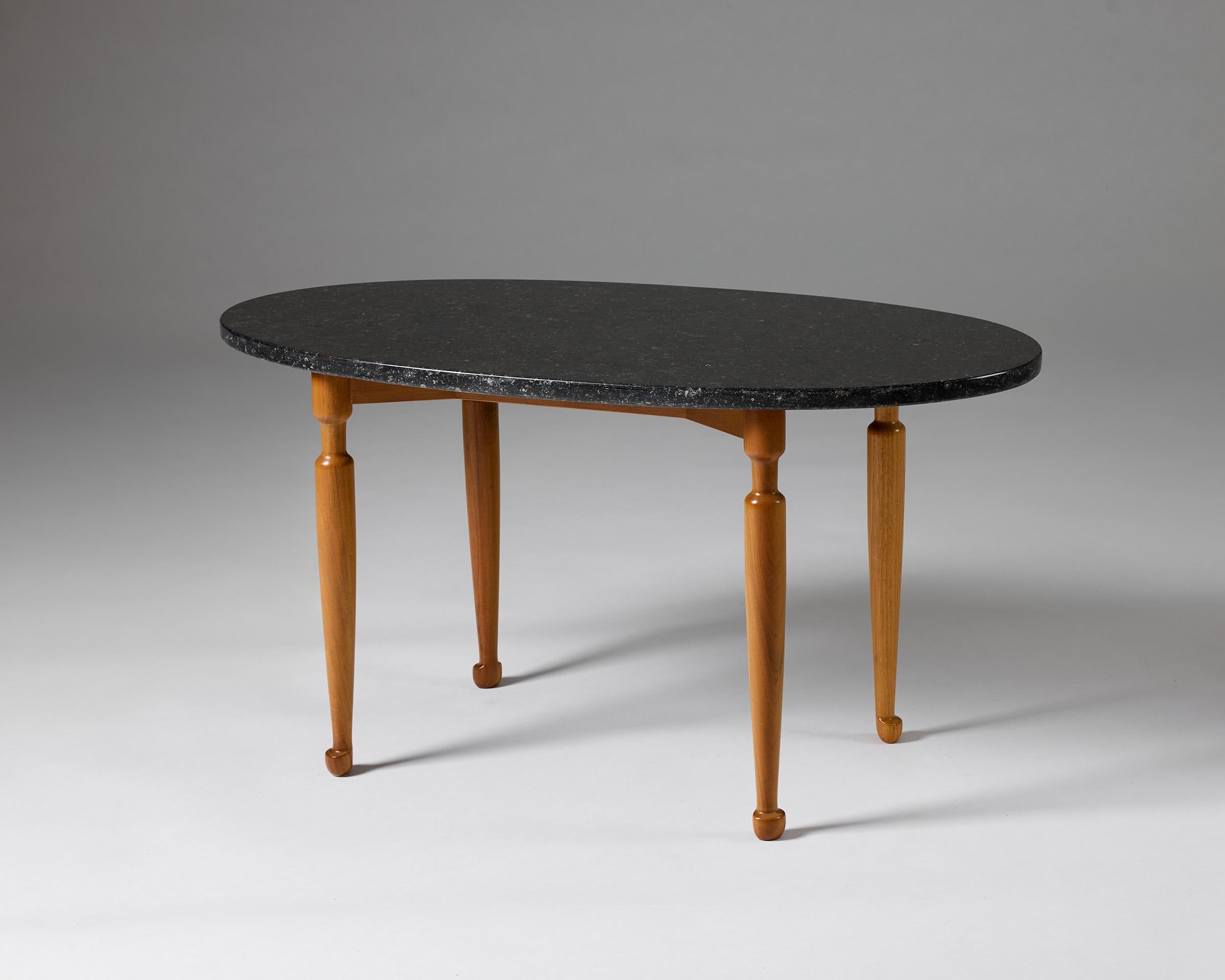 Occassional table model 1112 designed by Josef Frank for Svenskt Tenn, Sweden, 1950s

Stone top, walnut and stained beech base.

H: 45.5 cm / 1' 6