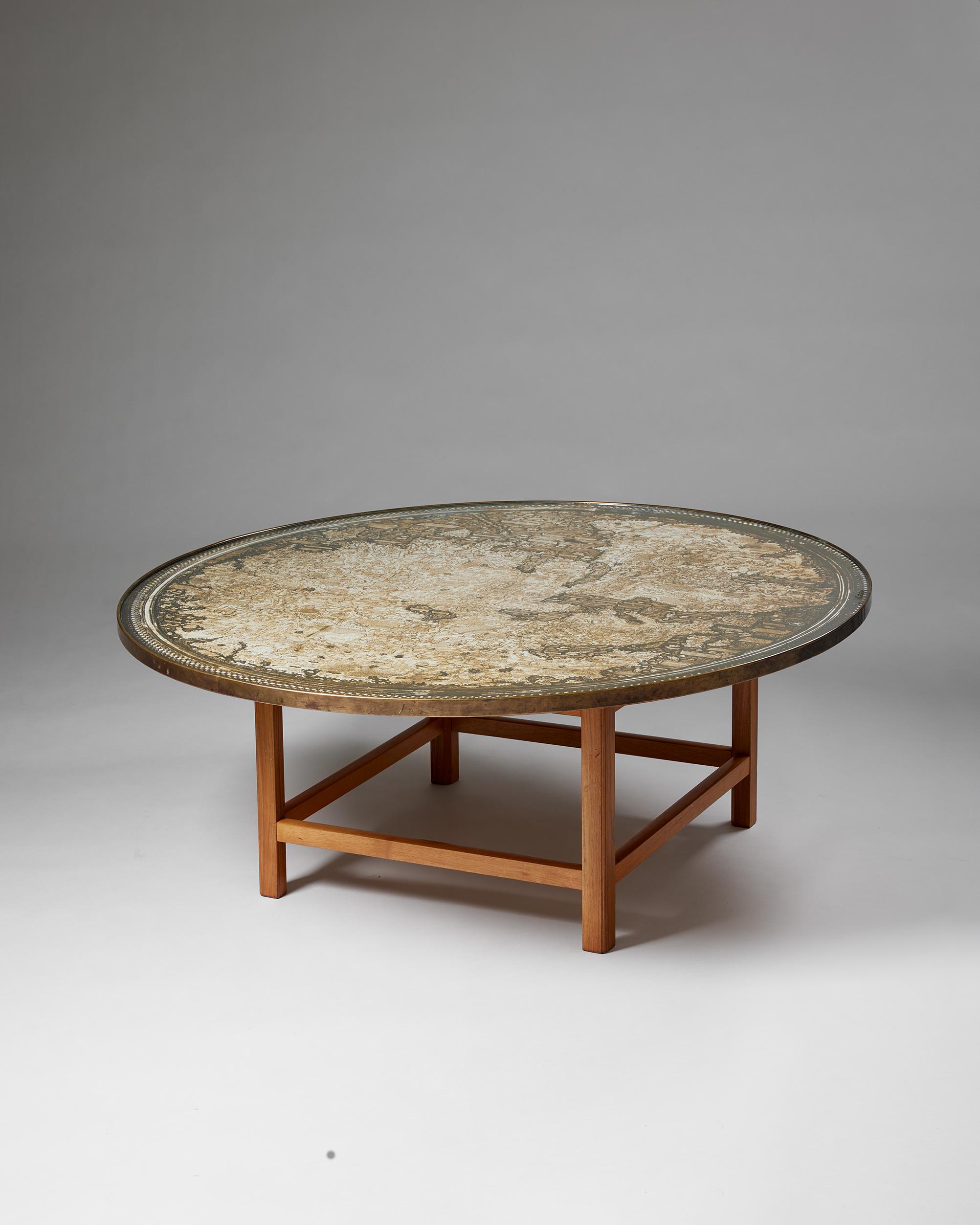 Occasional table model U 601 designed by Josef Frank for Svenskt Tenn,
Sweden, 1960s -1970s.

Mahogany, glass, and brass.

The map is a replica of the world map drawn by the Venetian monk and cartographer, Fra Mauro, ca 1450. The original map