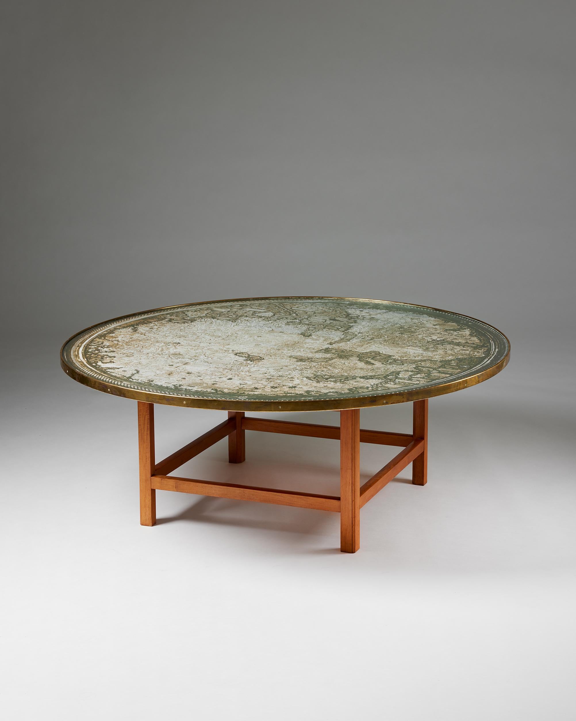 Occasional table model U 601 designed by Josef Frank for Svenskt Tenn,
Sweden, 1960s / 1970s.

Mahogany, glass and brass.

The map is a replica of the world map drawn by the Venetian monk and cartographer, Fra Mauro, ca 1450. The original map can be