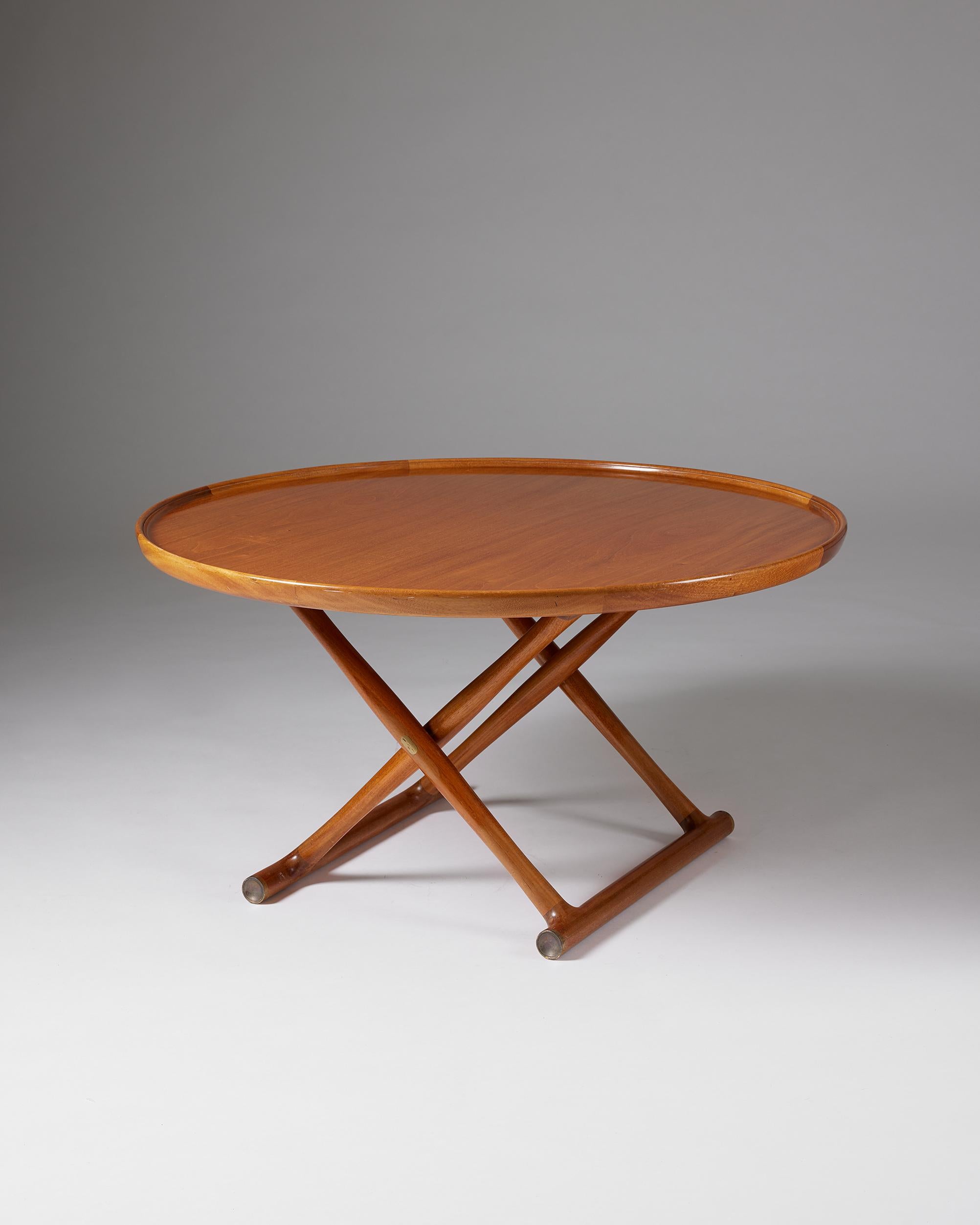 Occasional table ‘The Egyptian Table’ designed by Mogens Lassen for A.J. Iversen,
Denmark, 1960s.

Mahogany, foldable frame and top with raised edge, brass fittings.

With this occasional table model, Mogens Lassen created an icon of